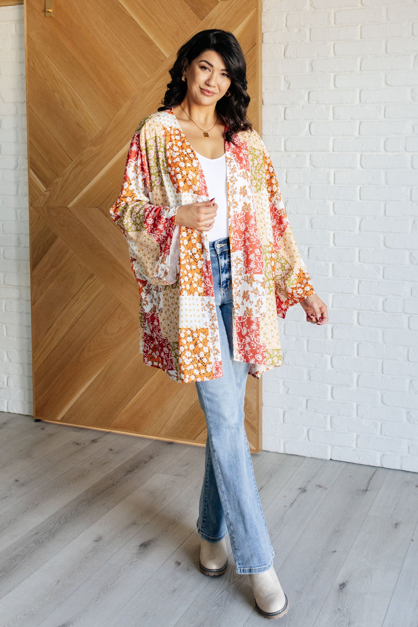 Full body view of model wearing Patch Mixed Floral Kimono layered over jeans and top.