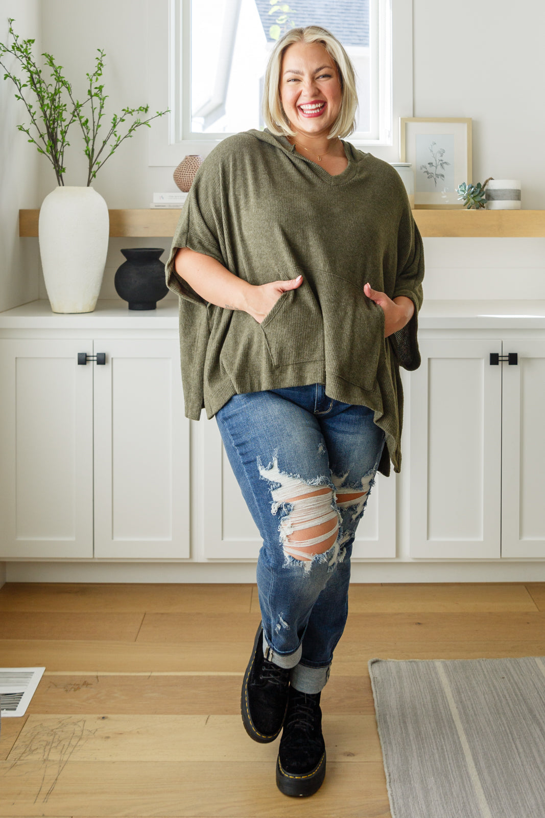 Plus size model full body wearing olive poncho top