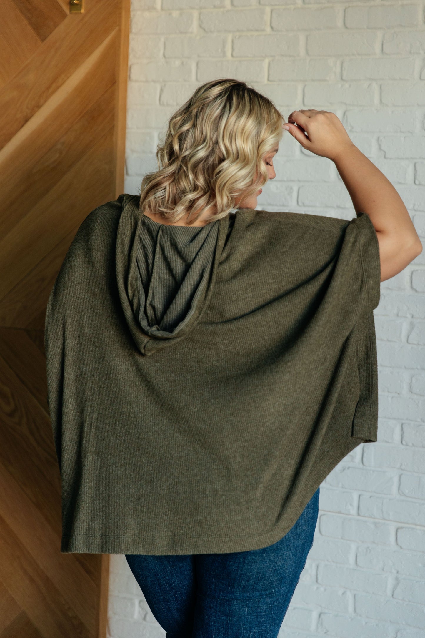 Plus size model back view showing poncho drape
