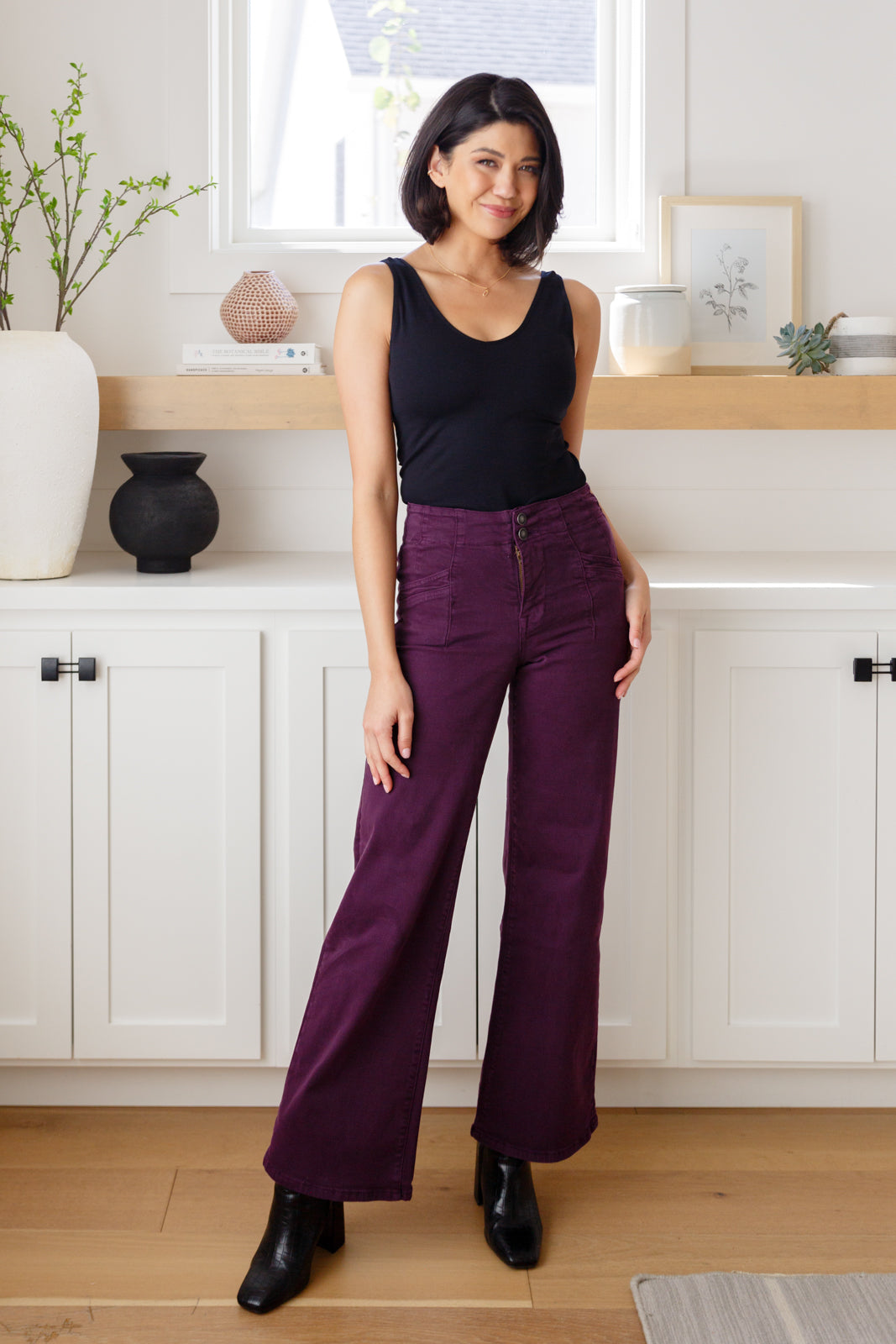 Full body view of Petunia Wide Leg Jeans in plum styled with neutral top and heels.