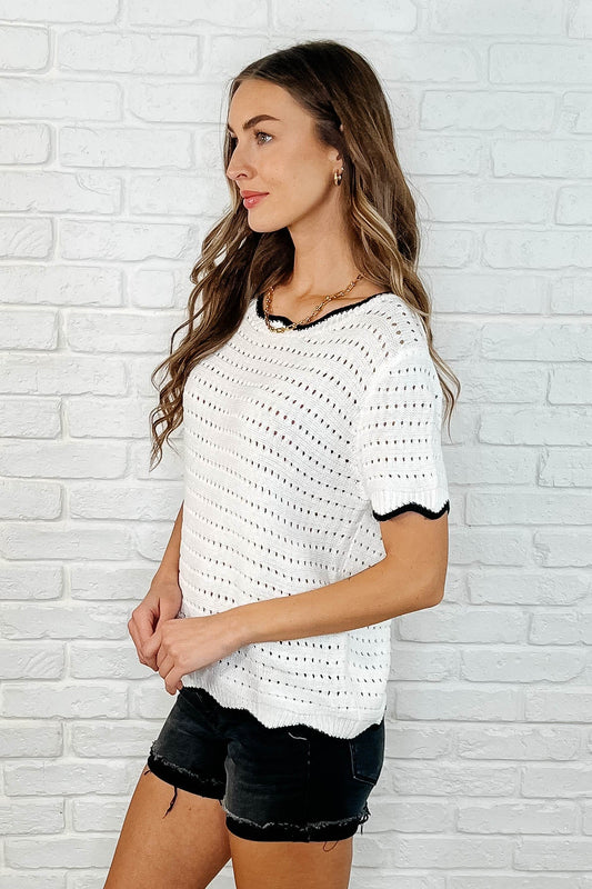 Side view of Pixie White Eyelet Knit Top showing playful contrasted sleeve cuff detail