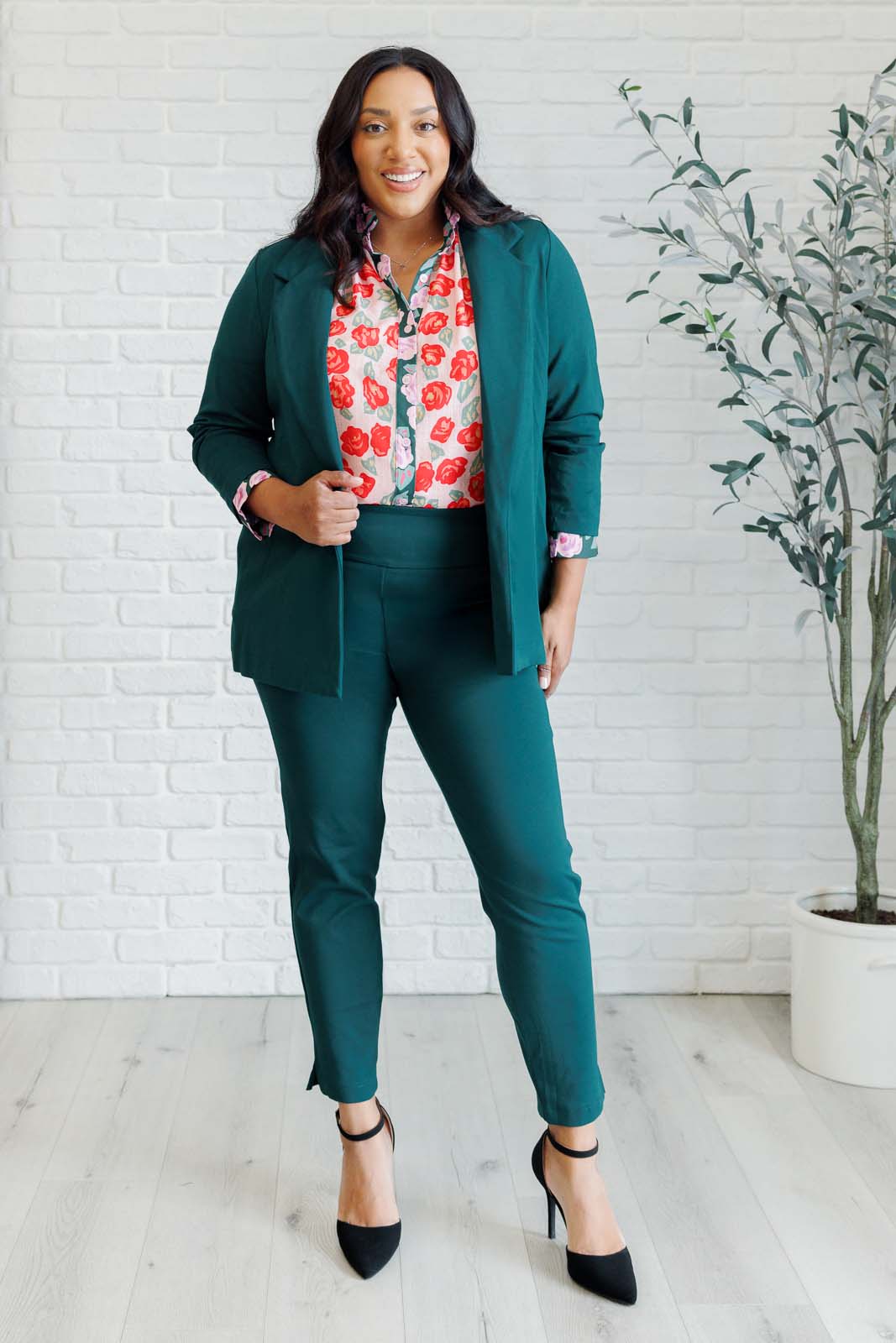 Plus size full body view of Gisselle Mixed Print Blouse styled with jeans showing playful ruffle detail.