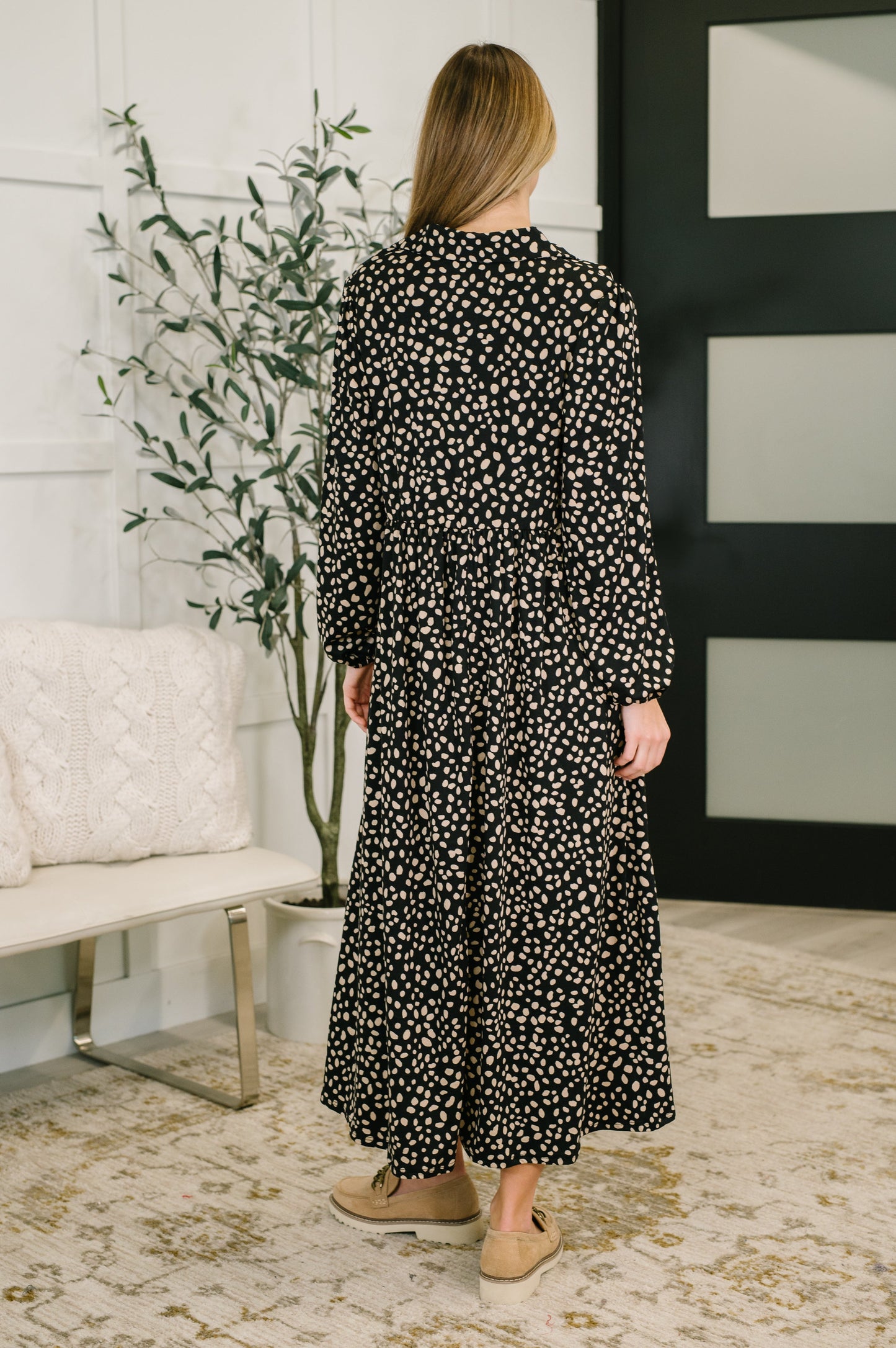 Back view of Pru Collared Dress in black showing relaxed silhouette and soft drape.