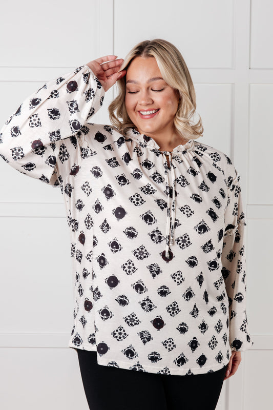 Plus size Quincy Floral Tile Blouse front view, white with black floral print, tie neckline and balloon sleeves.