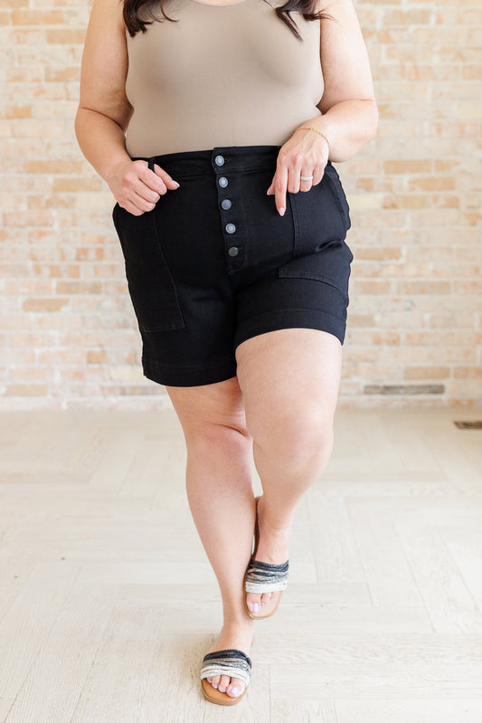 Plus size model front view of Reagan Judy Blue High Rise Trouser Shorts in sleek non-distressed black denim.