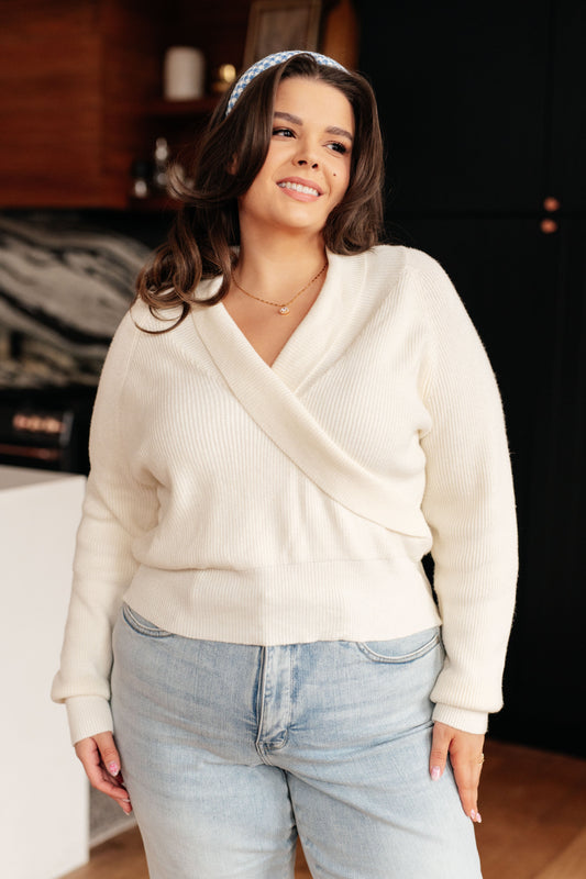 Plus size model wearing Raquel Surplice Crop Sweater in cream with faux wrap front.