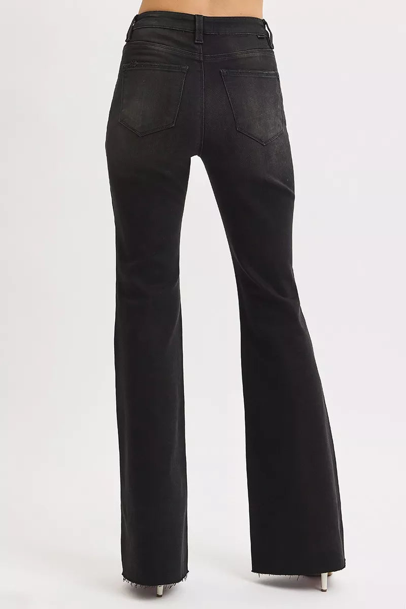Back view of Rhonda flare jeans with high rise waist and edgy raw hem finish.