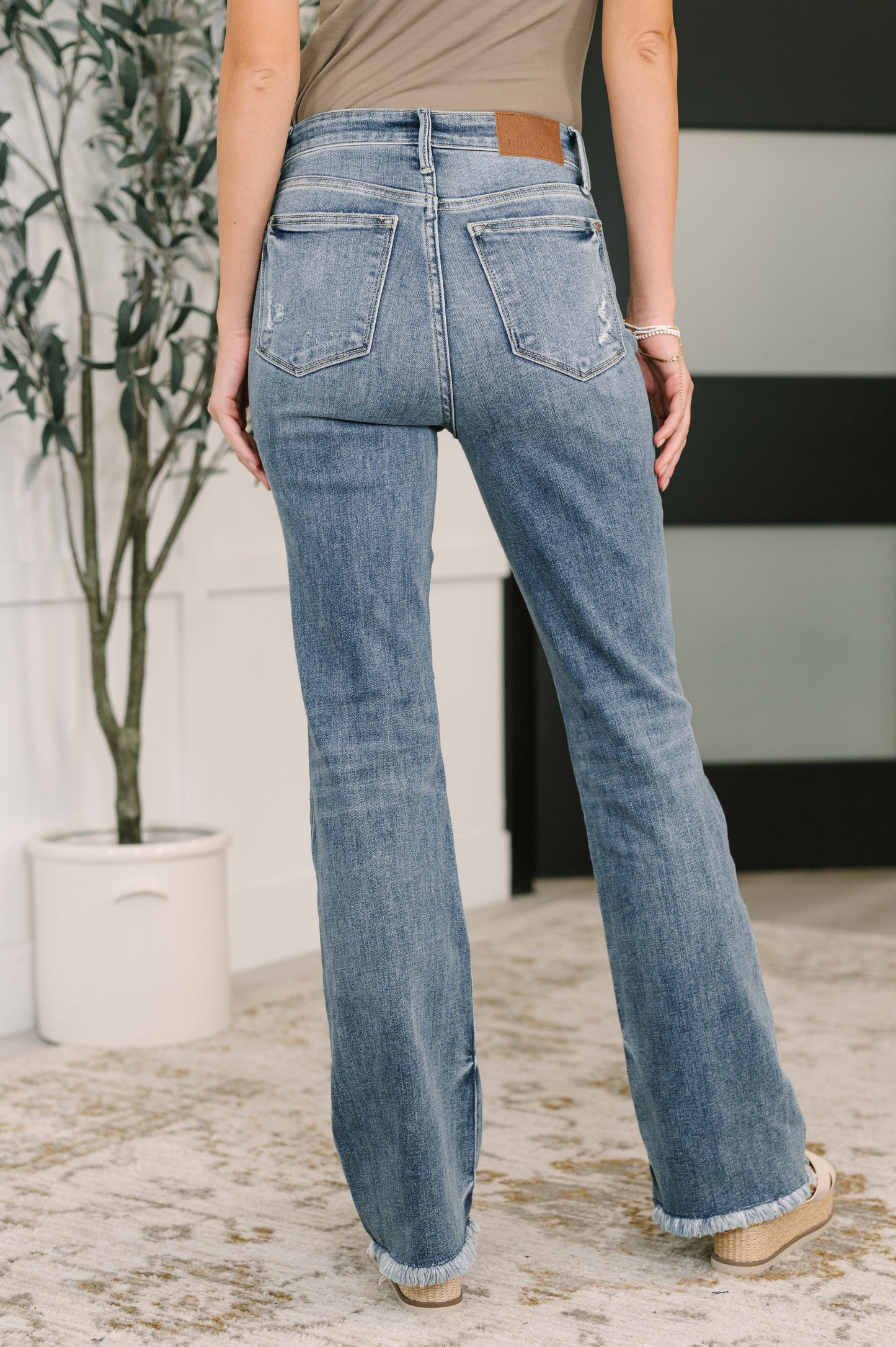 Robin High Waist Bootcut Jeans back view with high rise and light wash finish.