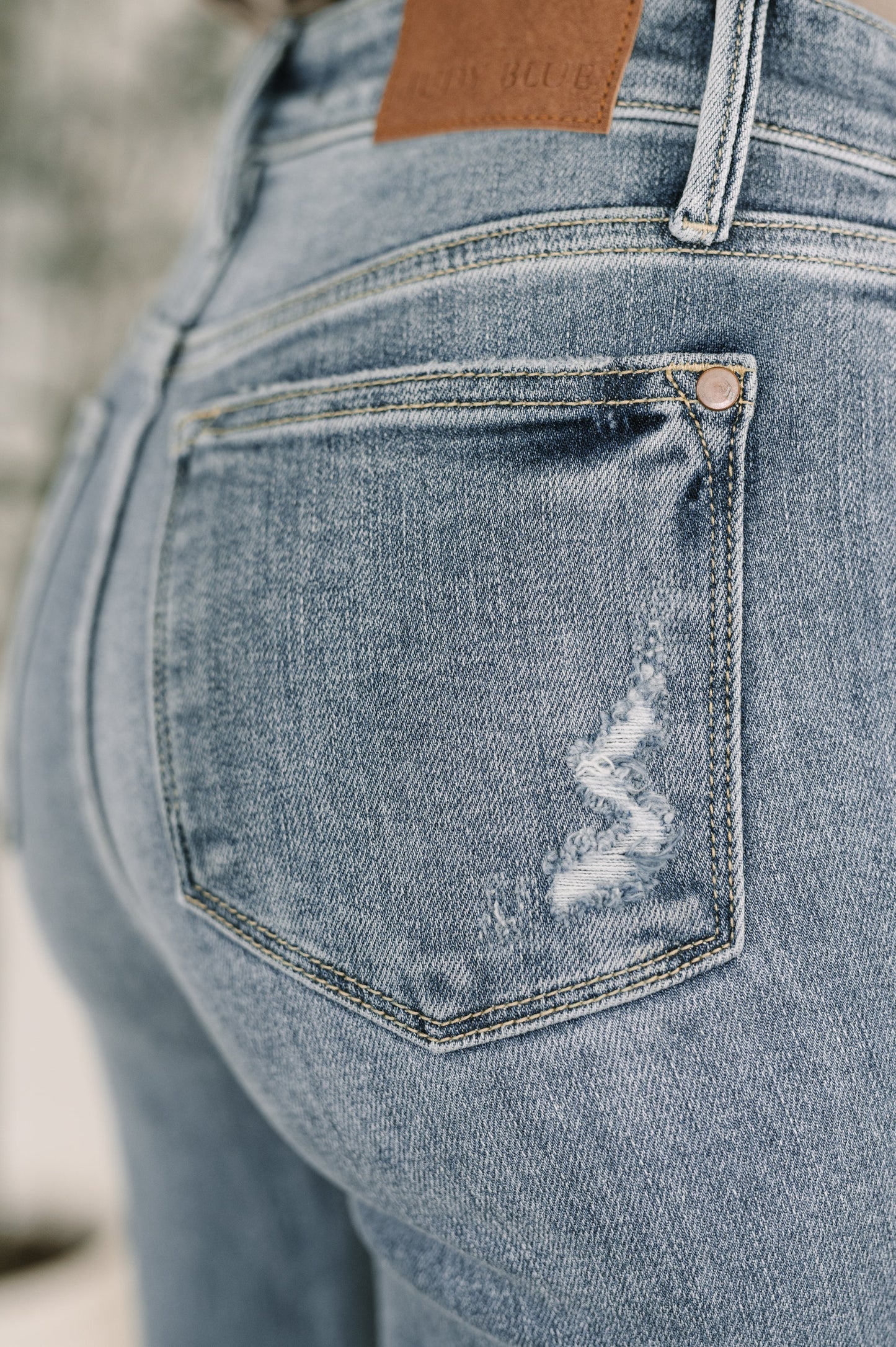 Robin High Waist Bootcut Jeans close up of back pocket.