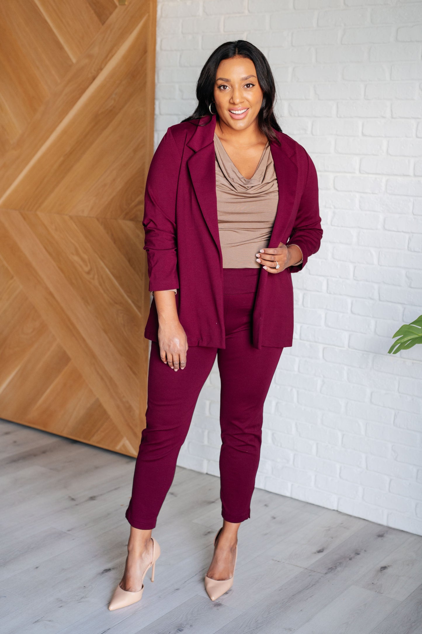 Plus size full body view of Midge Magic Skinny Pants in wine styled with pumps, featuring slim ponte fit and striking wine hue.