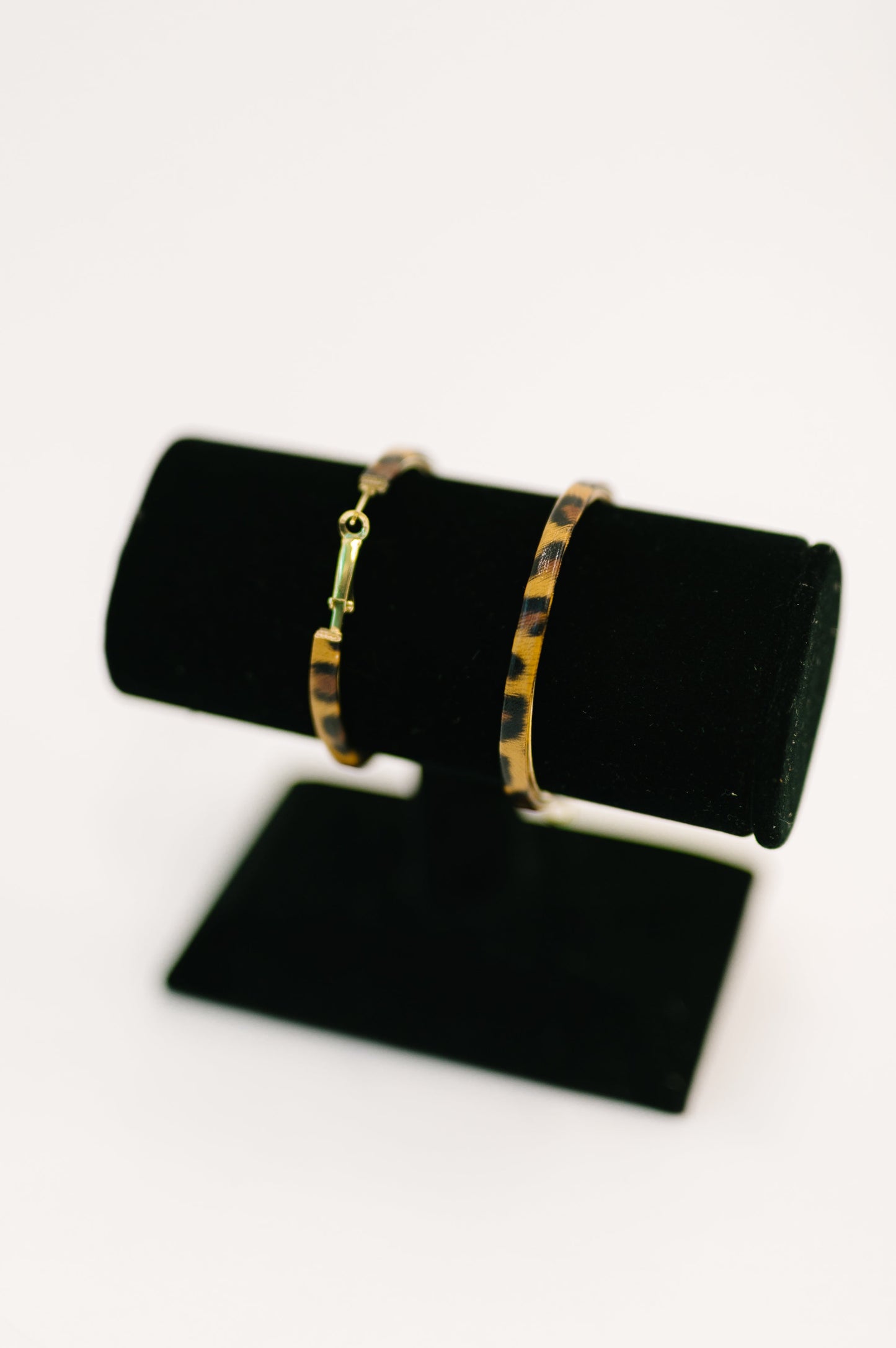 Flat lay of Sassy Assist Leopard Print Hoop Earrings statement hoop jewelry.