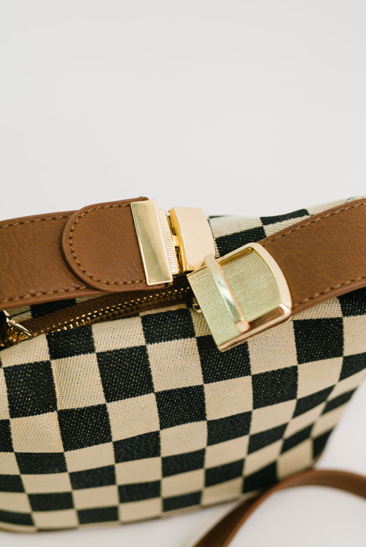 Detail shot of Send a Check Crossbody Bag gold hardware and buckle clip.