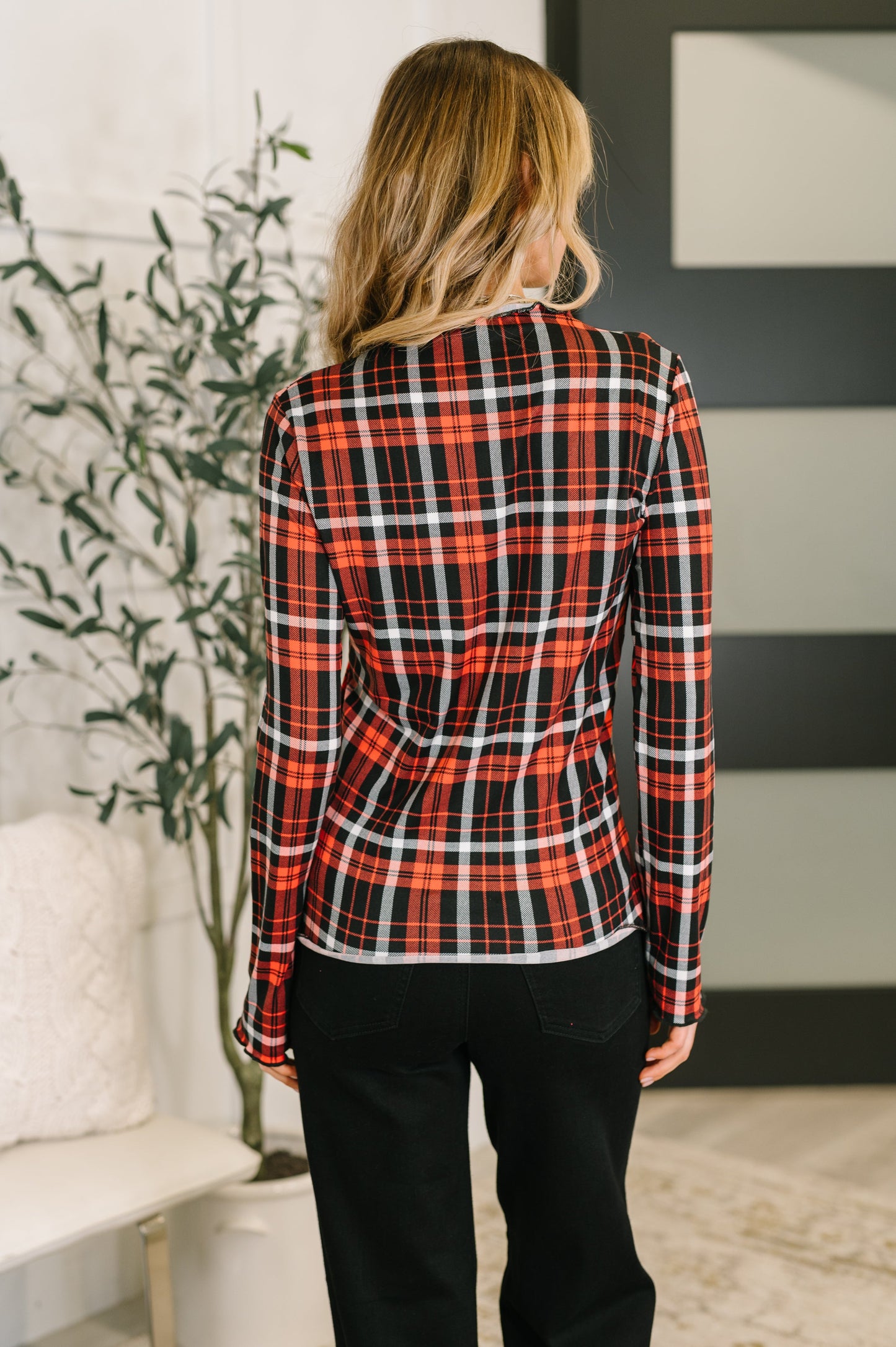 Back view of Shane Plaid Lettuce Hem Top showing high-stretch knit fabric.