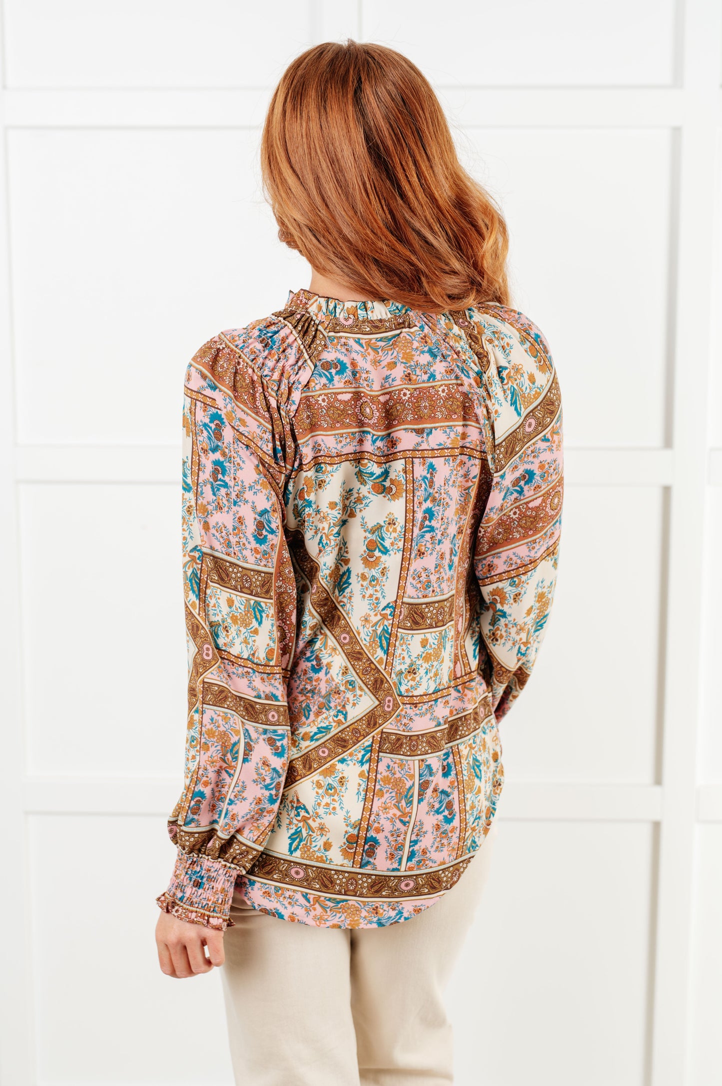 Back of Elise Mixed Print Peasant Blouse featuring patchwork print and high-low hem.