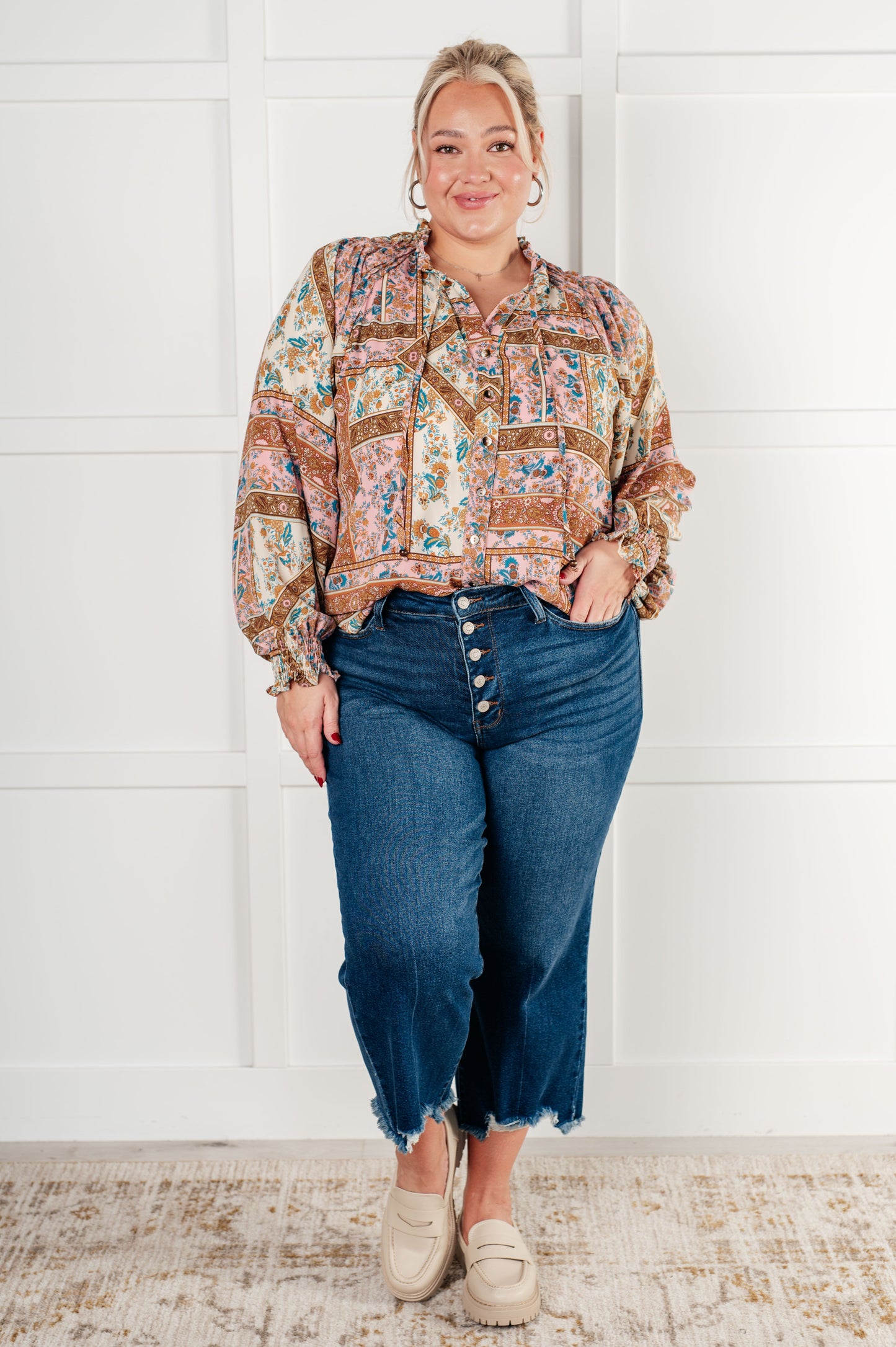 Plus-size model wearing Elise blouse tucked into jeans with loafers.