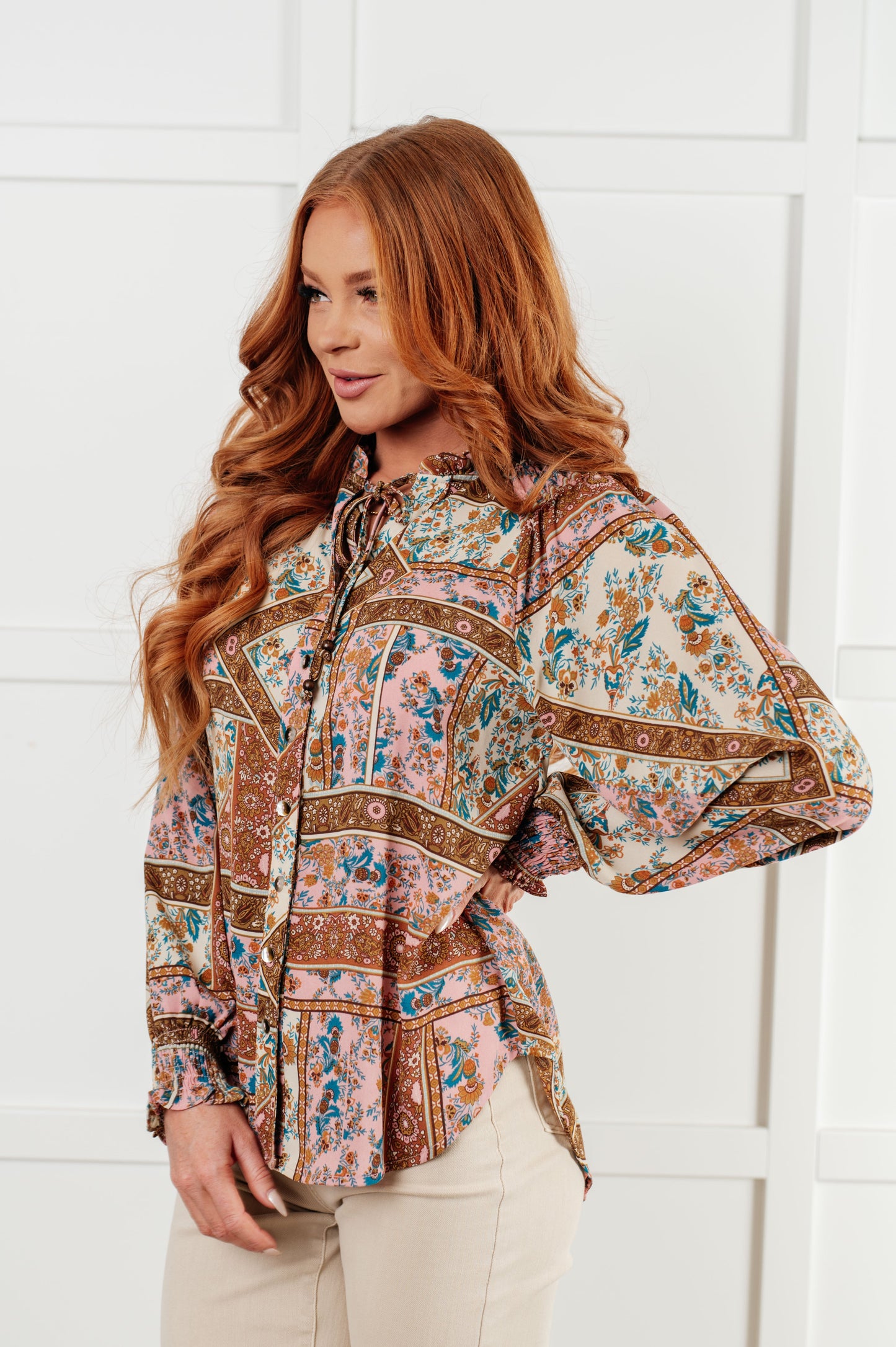 Model in Elise Mixed Print Peasant Blouse showing balloon sleeve and smocked cuff.