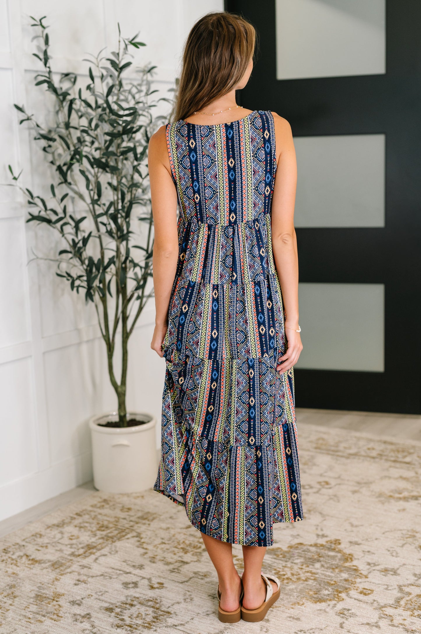Back view of Sierra Gathered Tiered Dress with sleeveless cut and tiered gathered silhouette in navy knit.