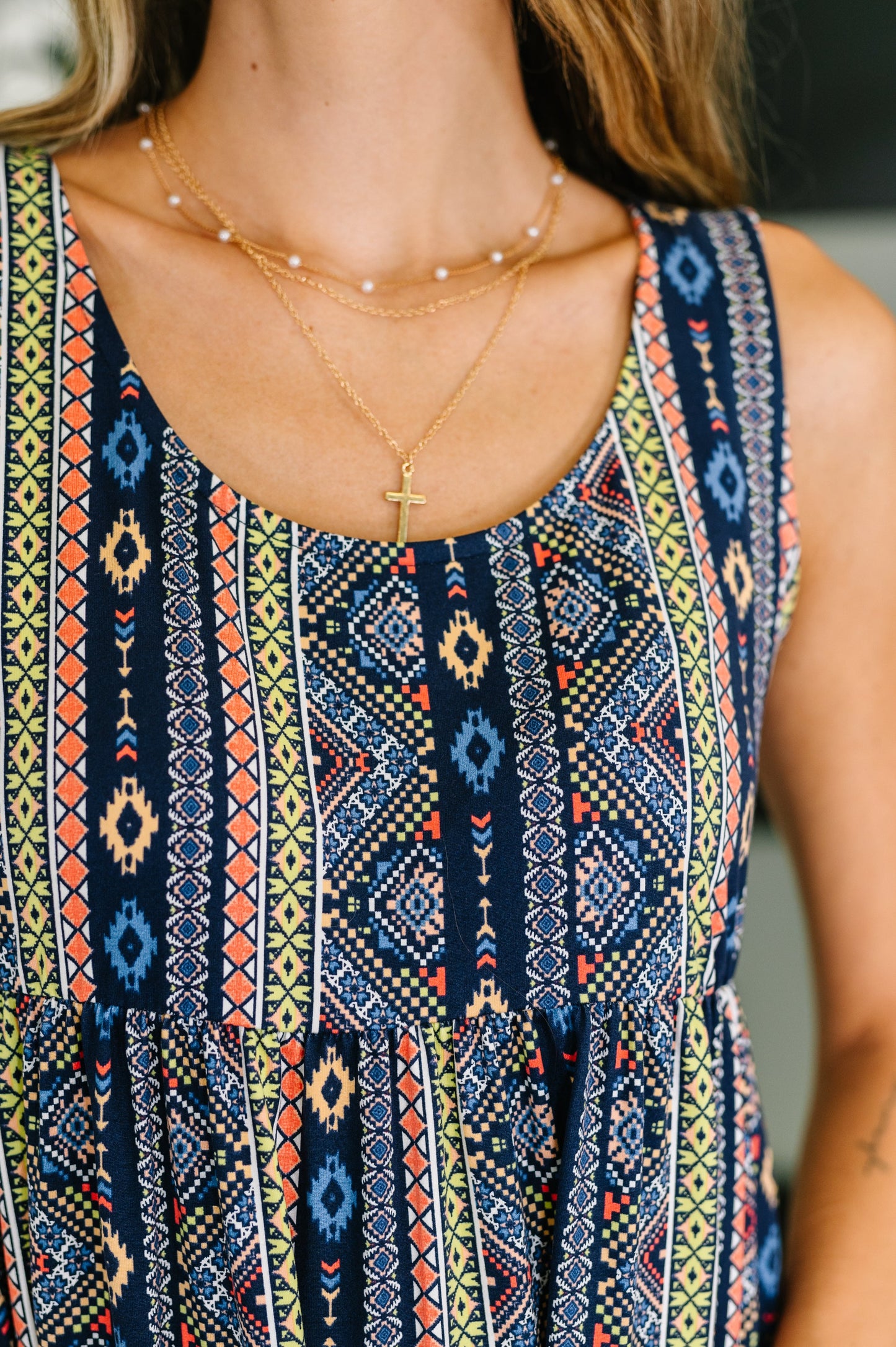 Close-up of Sierra Gathered Tiered Dress showing scooped neckline, sleeveless detail, and gathered tiered knit fabric.