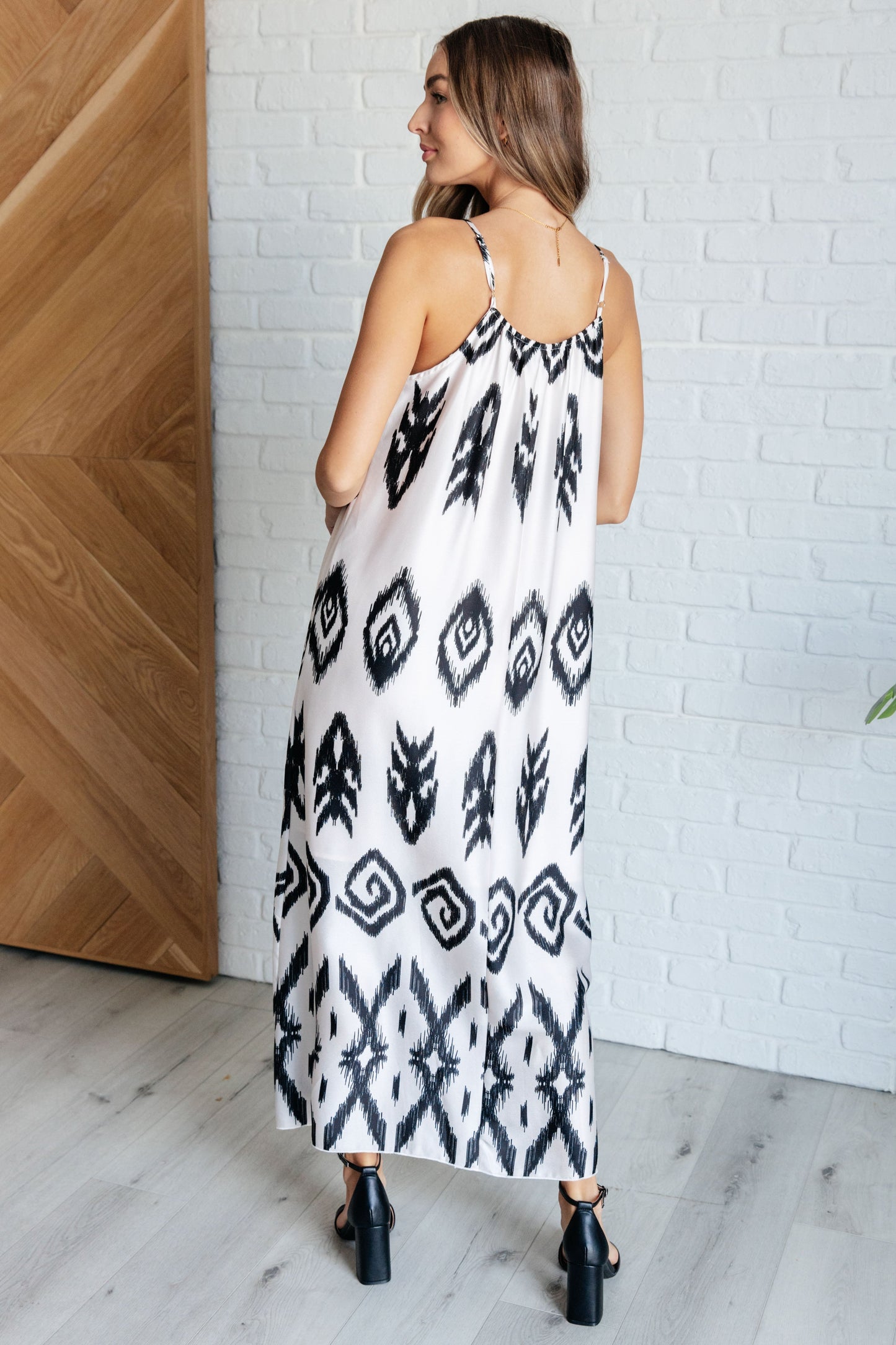 Back view of Sigrid Maxi Dress in ivory with geometric pattern and adjustable spaghetti straps.