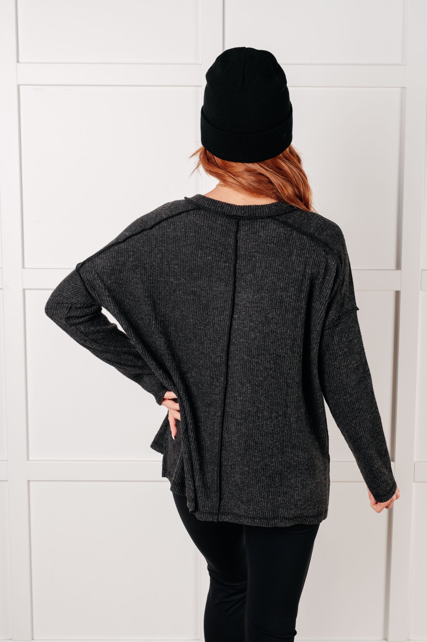 Back view of black Simon Ribbed Hacci Sweater showing ribbed texture and drop shoulder long sleeves.