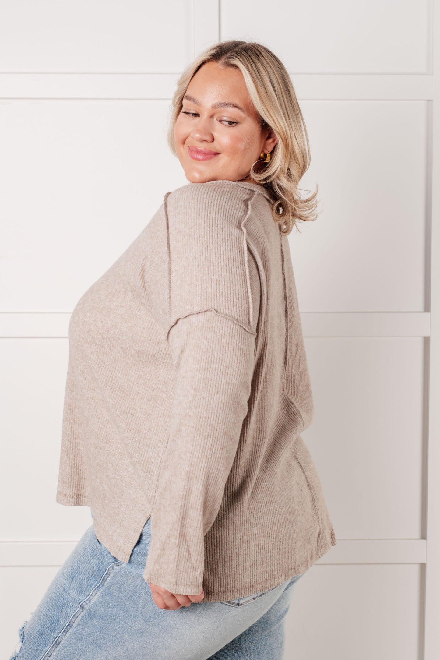 Plus size side view of Simon Ribbed Hacci Sweater with exposed seams, side slit detail, and casual drape.