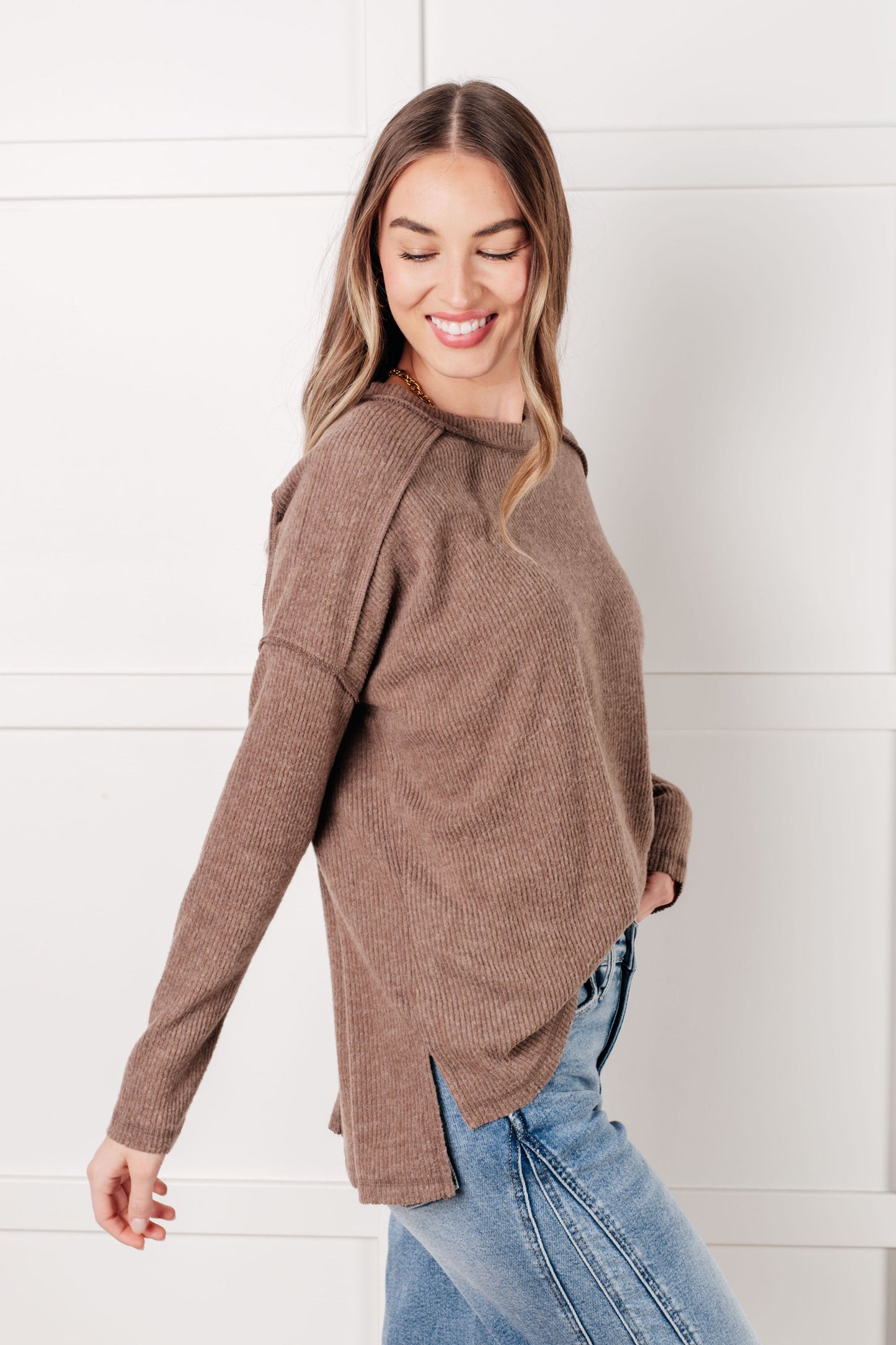 Side view of mocha Simon Ribbed Hacci Sweater showing relaxed fit with exposed seams and side slit detail.