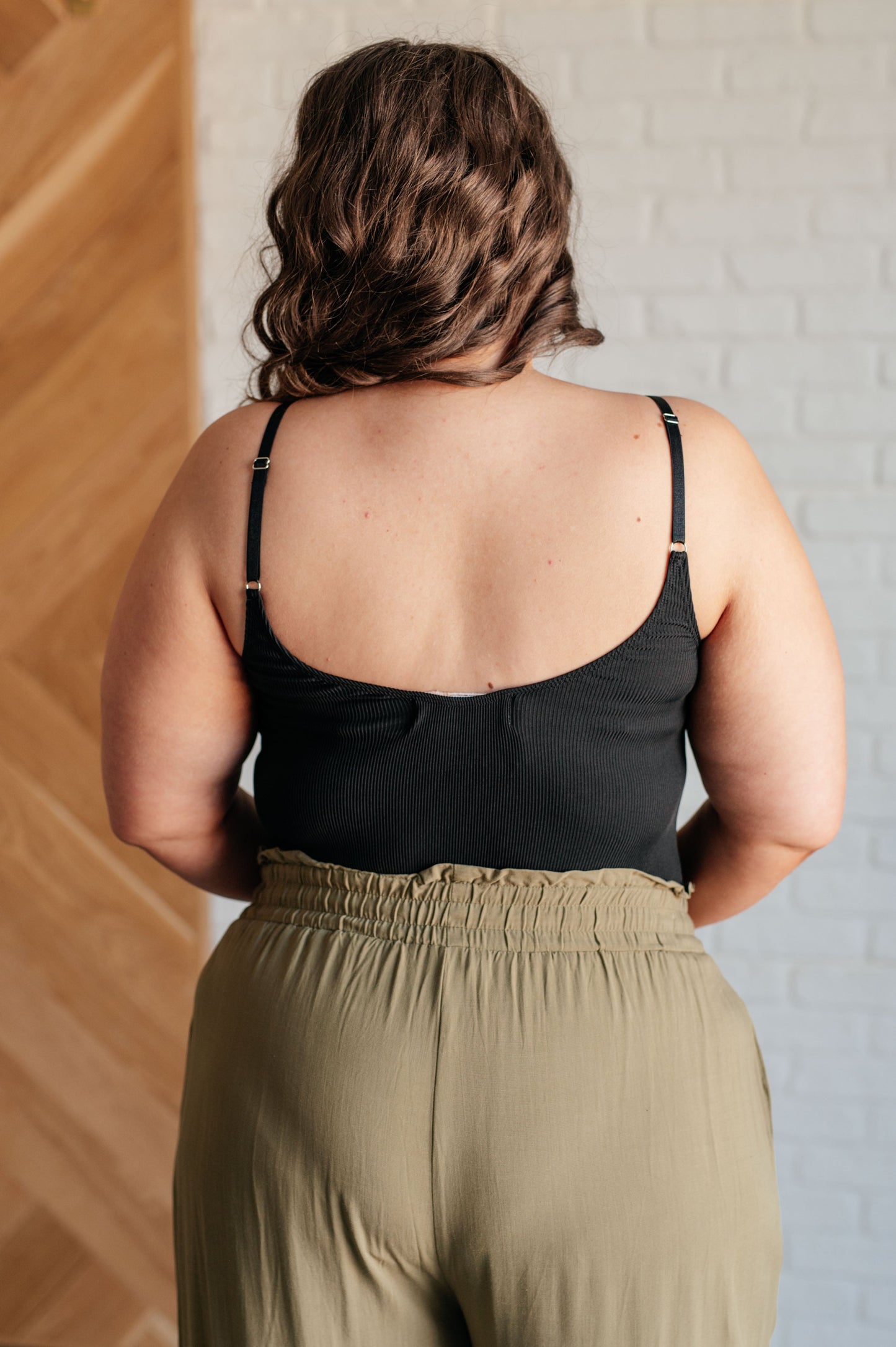 Plus size back view of Saylor Ribbed Knit Bodysuit highlighting ribbed knit texture and thong bottom.