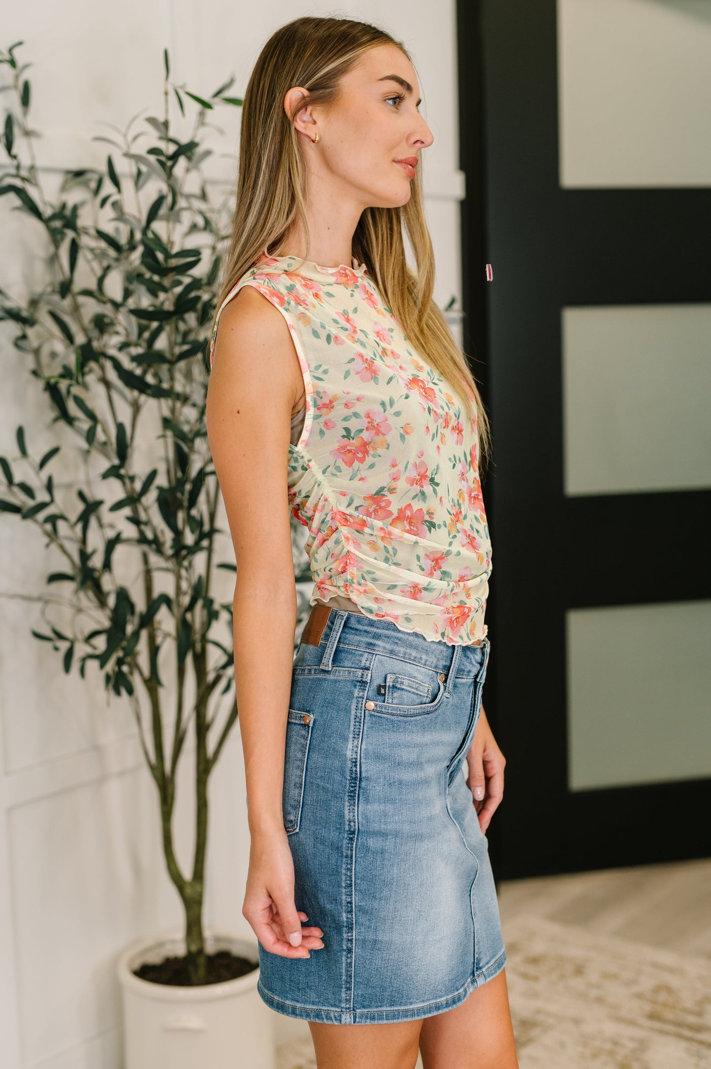 Side view of model wearing the Zya sheer chartreuse tank, highlighting the ruched sides and curve-hugging fit.