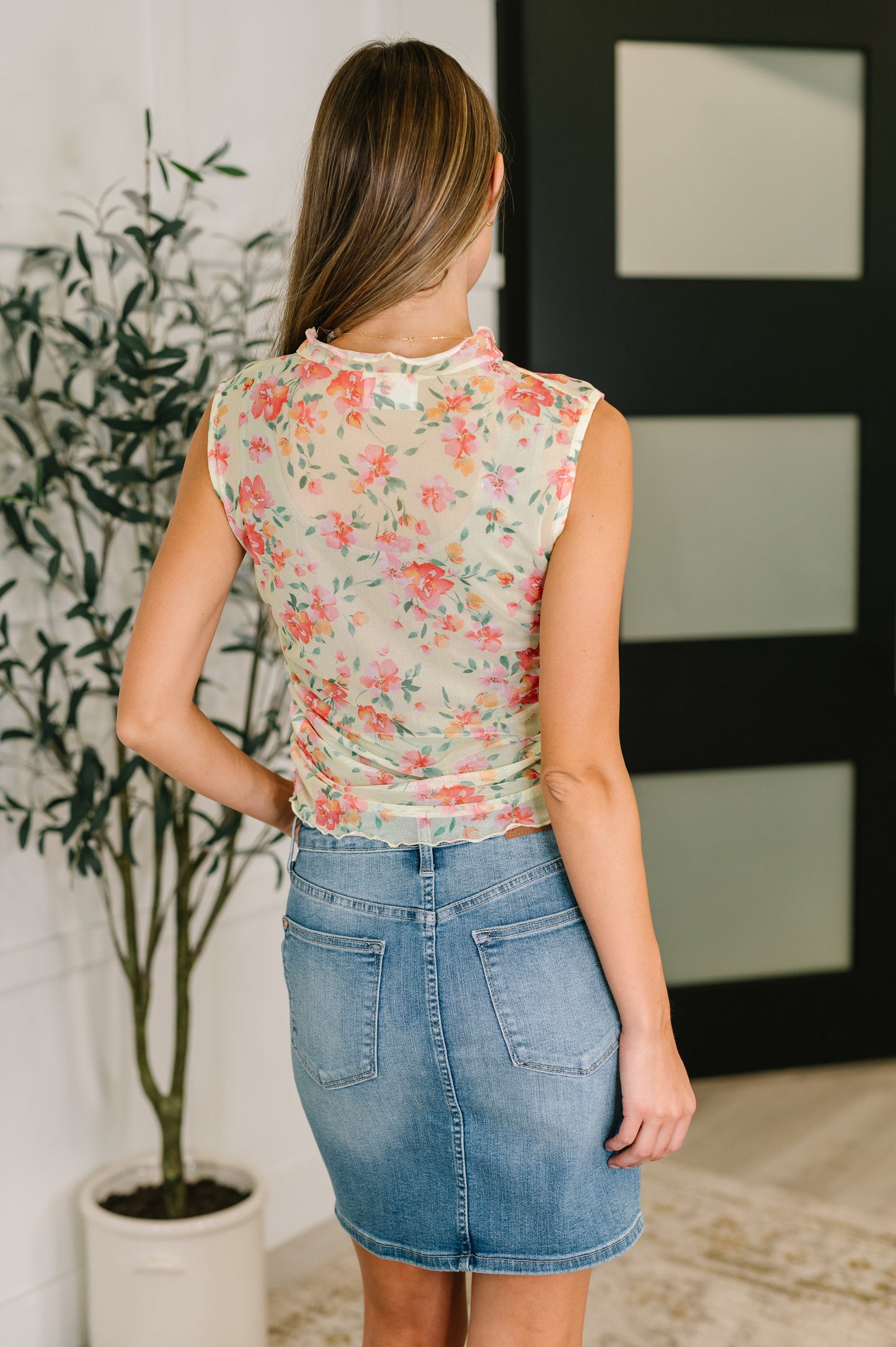 Back view of model wearing the Zya Sheer Layering Tank in chartreuse, showcasing sheer mesh fabric and lettuce hem.