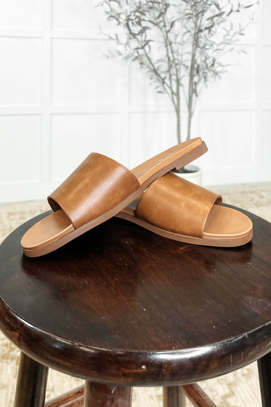 Sole Mate tan slip on sandals with open round toe and single band design, comfortable and stylish footwear.