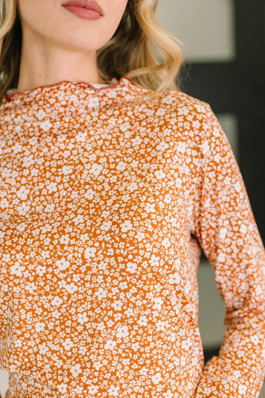 Close-up of Sondria Lettuce Hem Top showing lettuce neckline and sleeve cuffs.