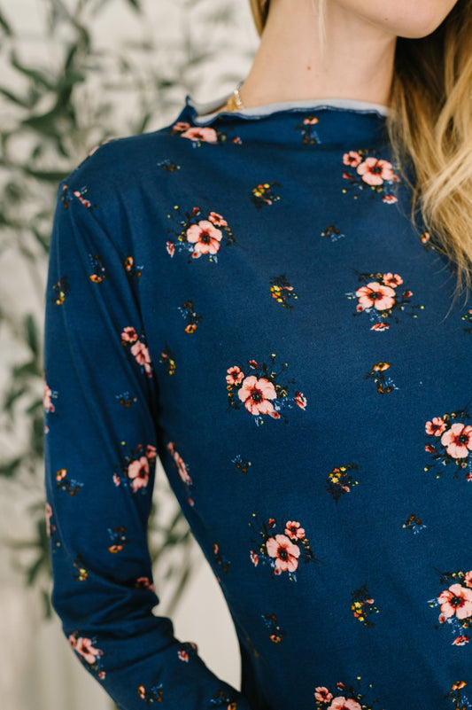 Close-up of Sondria Lettuce Hem Top showing lettuce neckline and floral details.