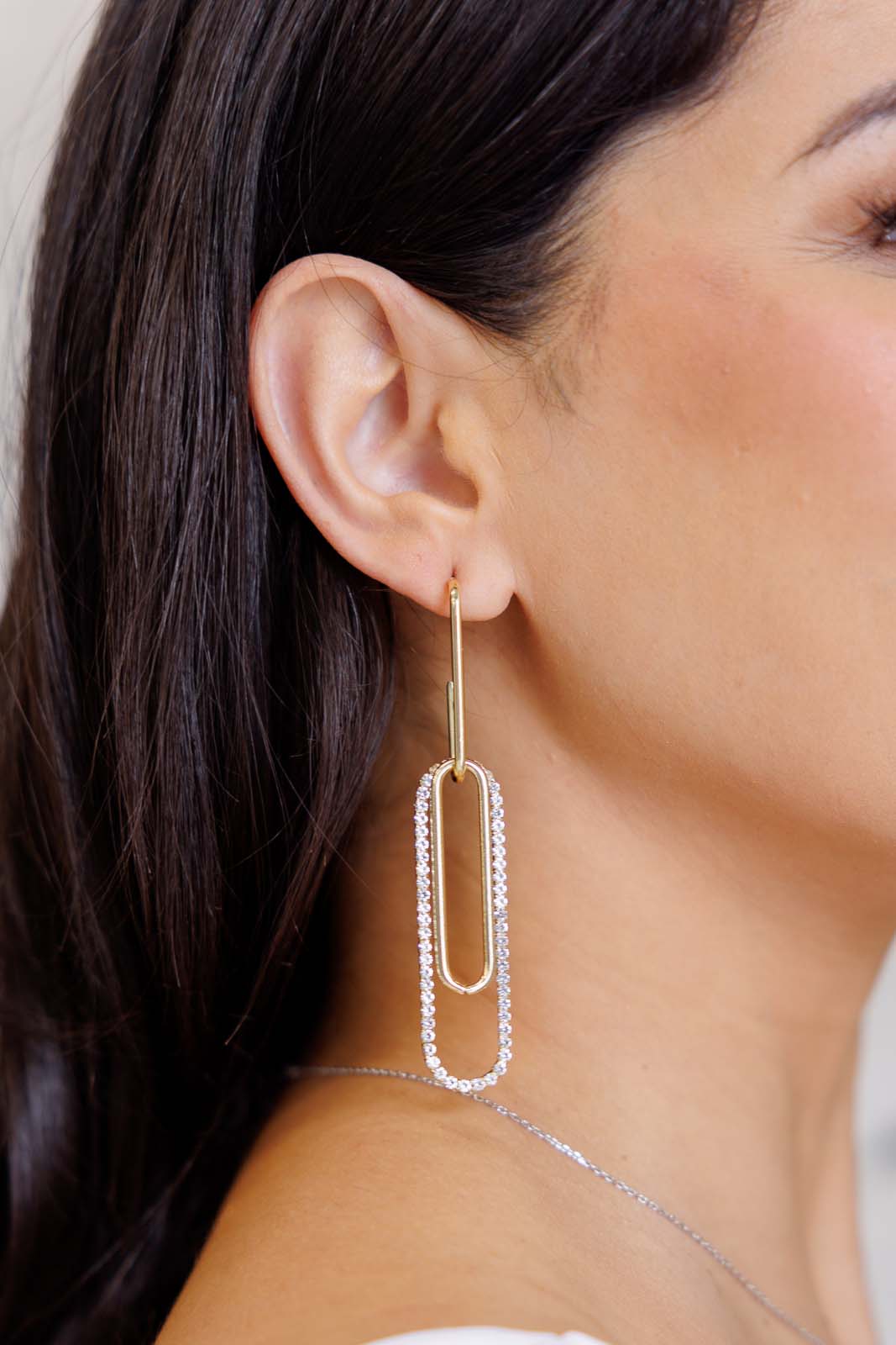 Woman wearing Sonia Link Earrings with gold finish and rhinestone accents