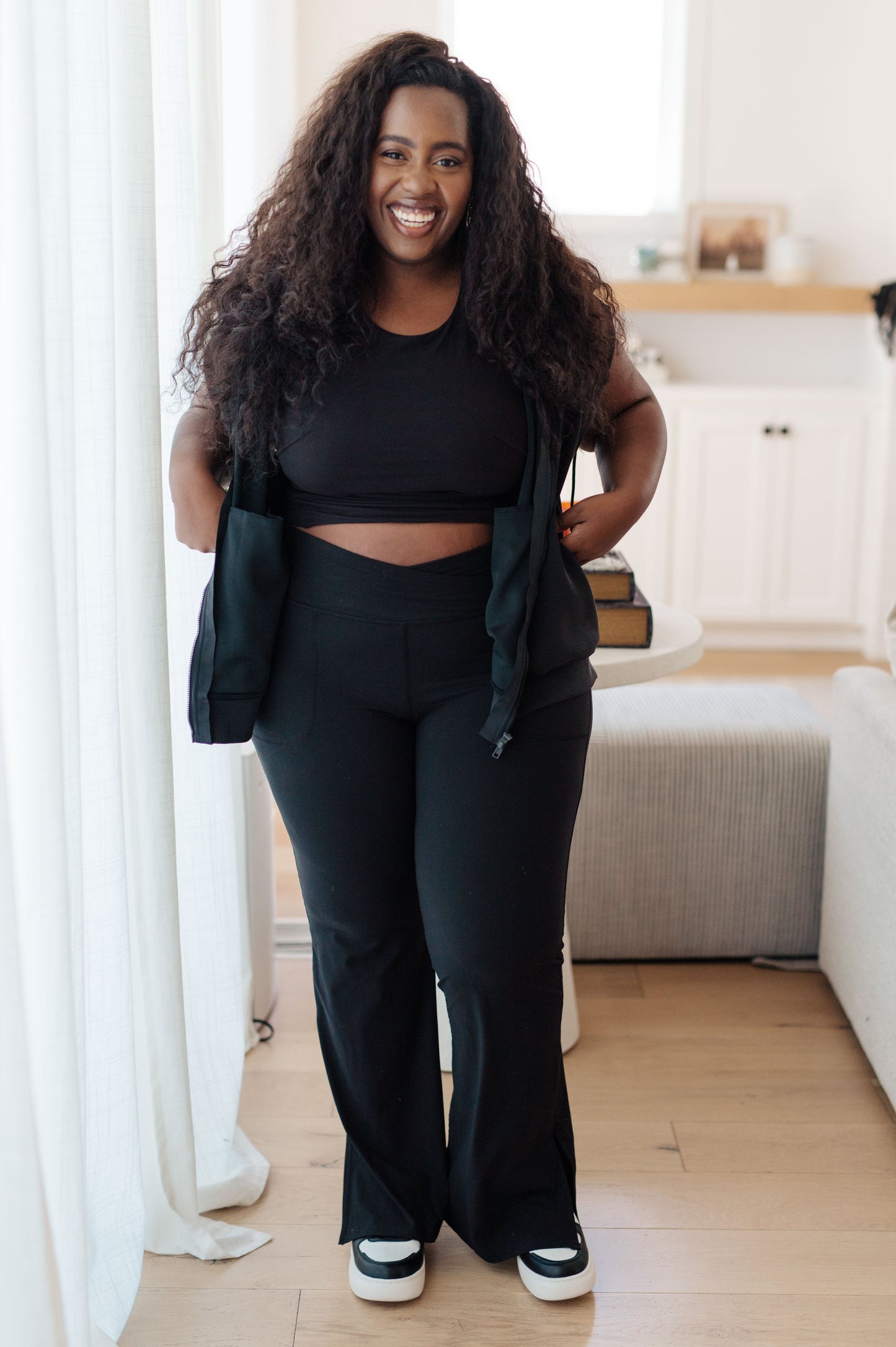 Plus-sized model wearing the Isabella Sleeveless Hoodie paired with athletic wear, highlighting its sporty, breathable design.