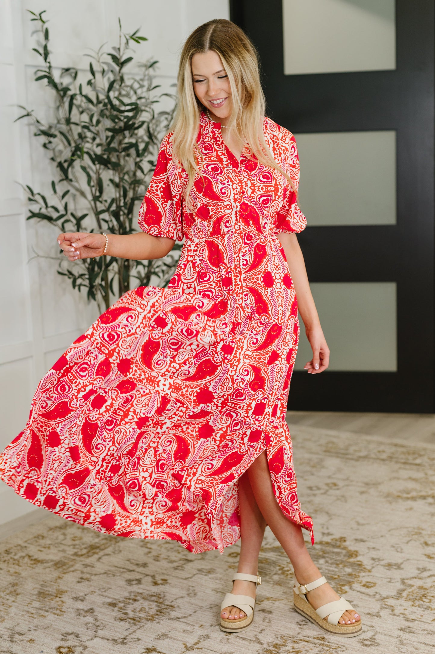 Front-facing full body image of model in Jemma Maxi Dress striking a playful pose, styled with sandals for a summer-ready look.