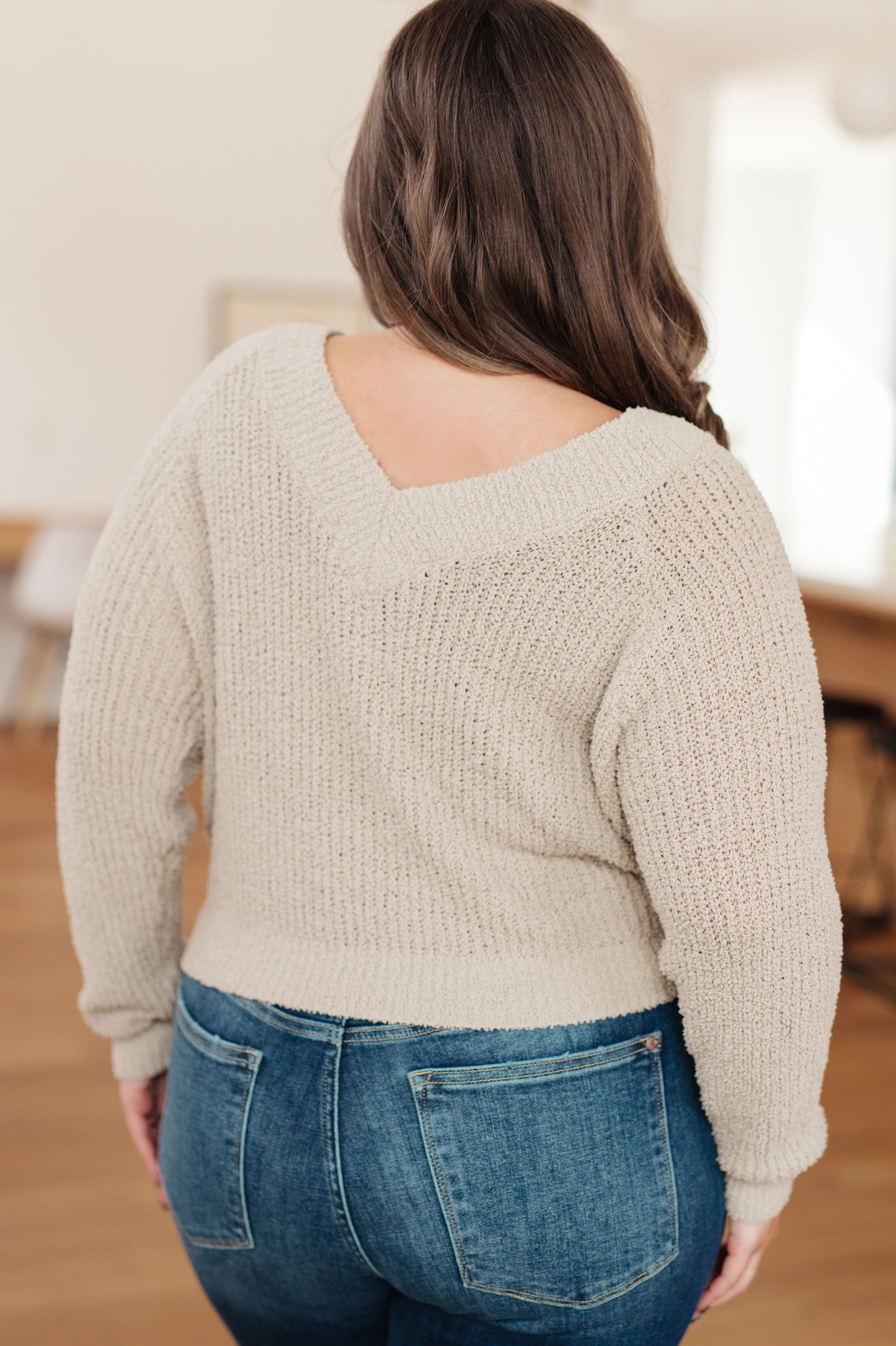 Back view of plus size Suki V-Neck Sweater showing V-neck and relaxed fit.