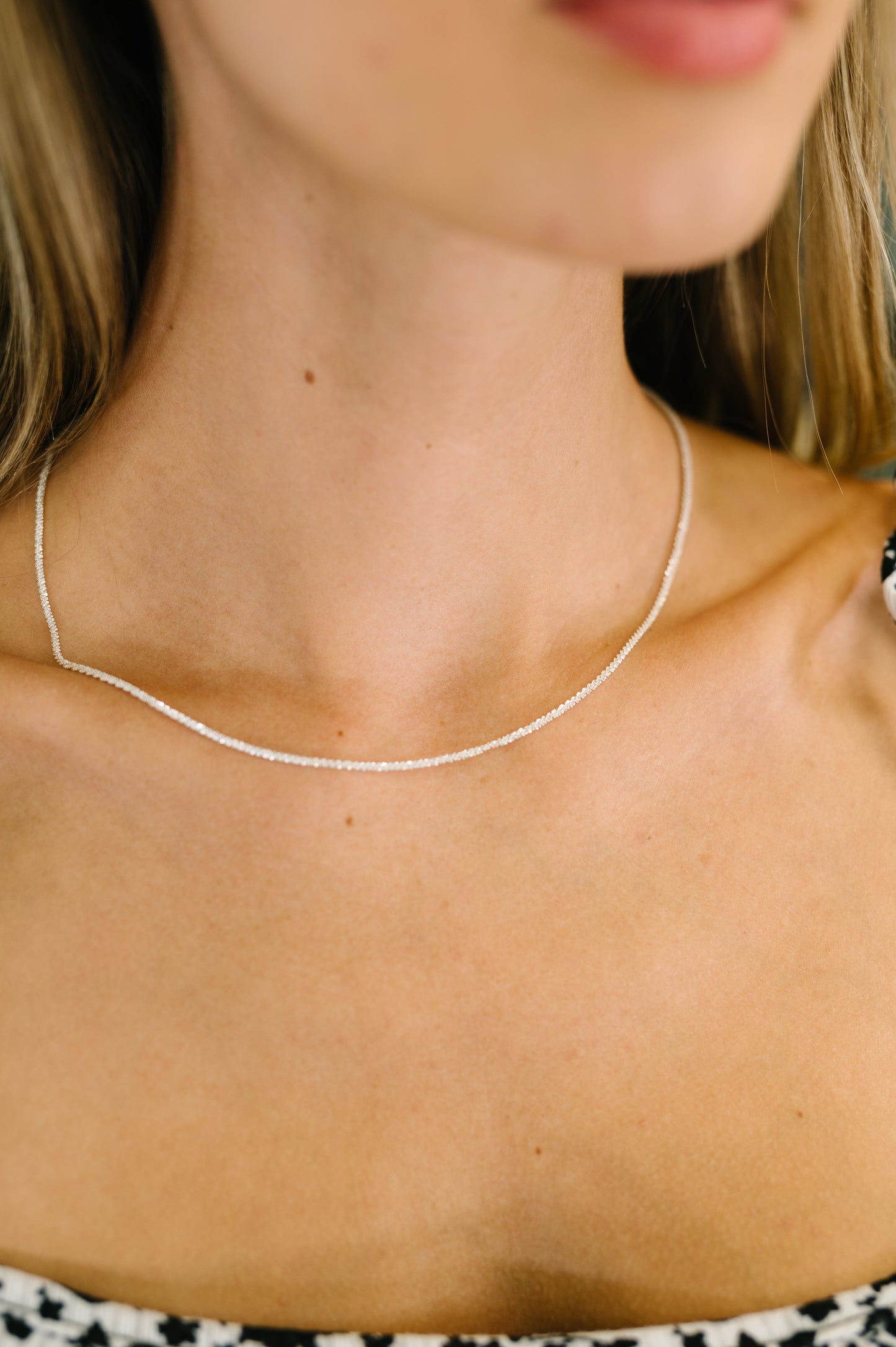 Subtle Sparkle Dainty Necklace on model, twisted 925 silver chain with delicate shine and adjustable extender