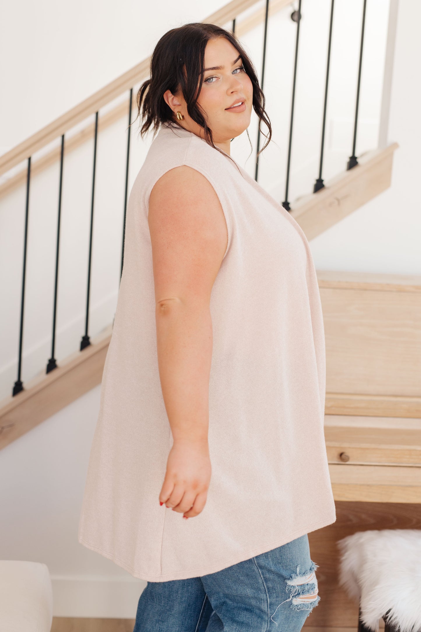 Plus size side view of Priscilla Sleeveless Cardigan in cream with shawl collar and open front design.