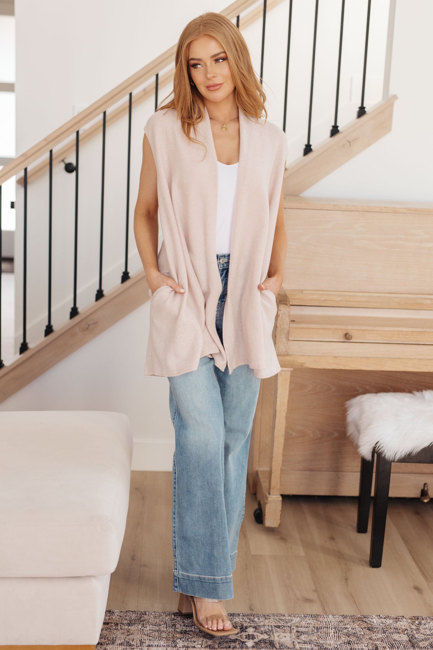 Full body view of cream Priscilla Sleeveless Cardigan styled with open front and convenient side pockets.