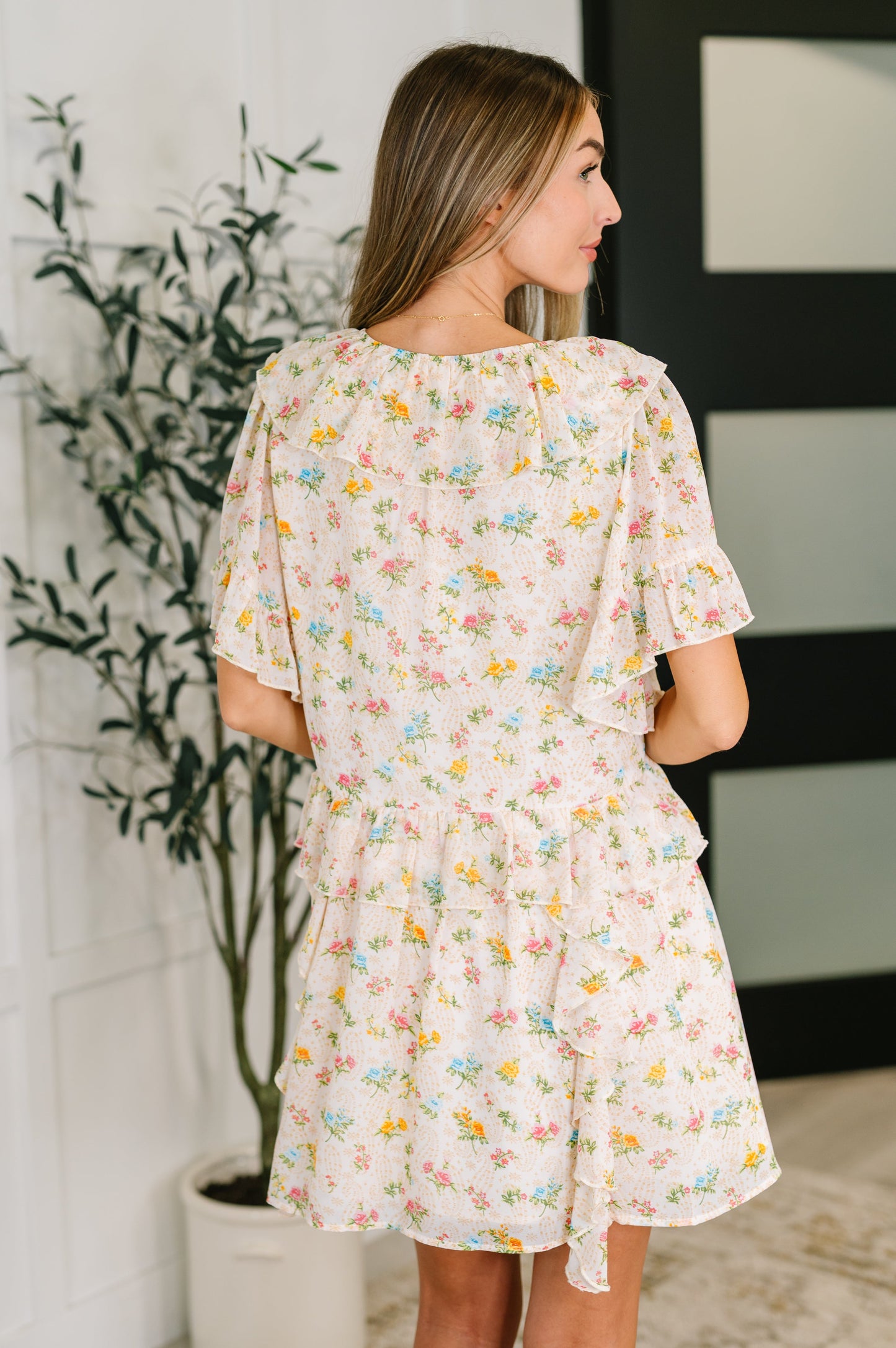 Back view of the Addison Boho Floral Dress highlighting the ruffle details and relaxed fit.