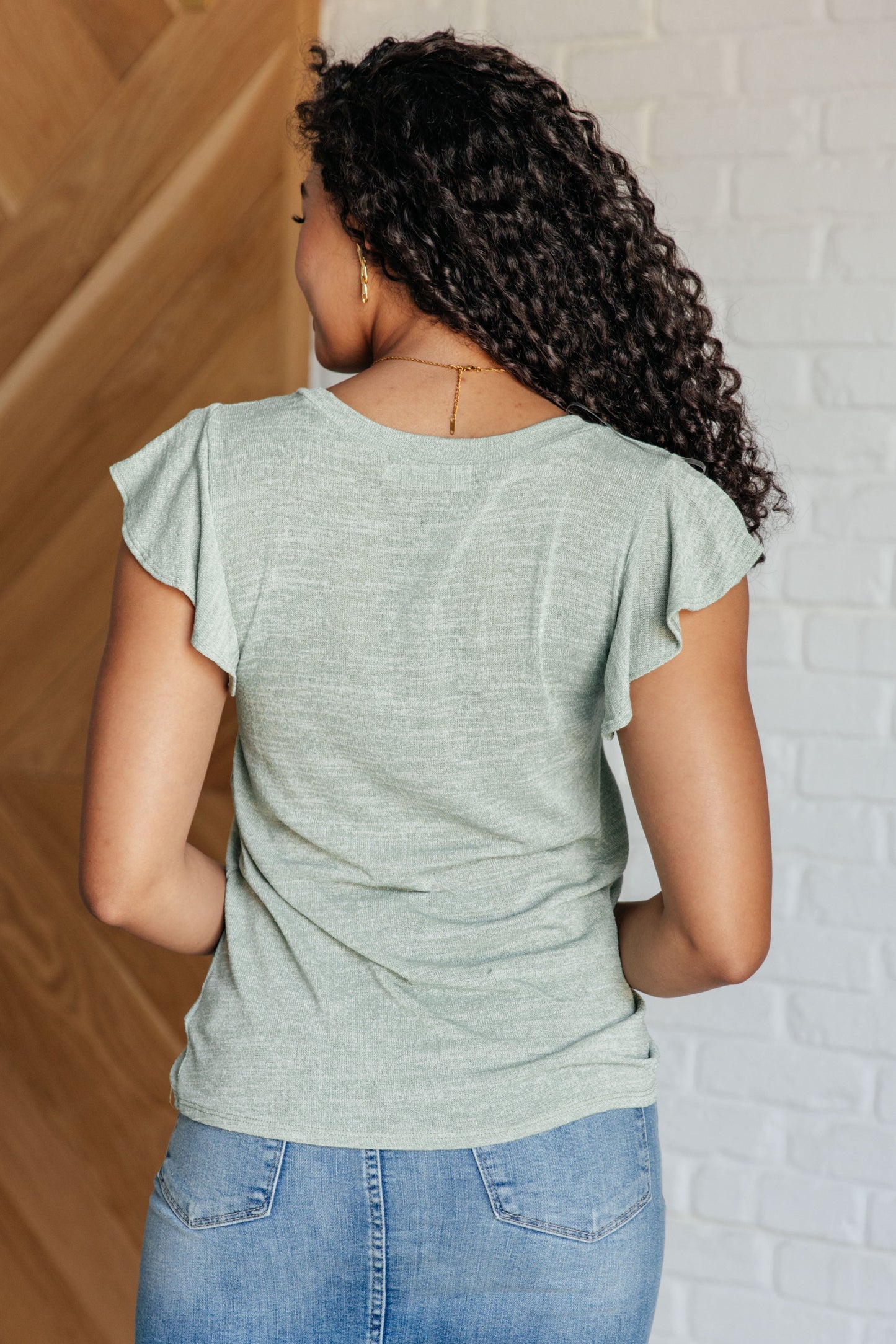 Back view of Teresa Flutter Sleeve Top in sage slub jersey knit with relaxed fit and flutter sleeve design
