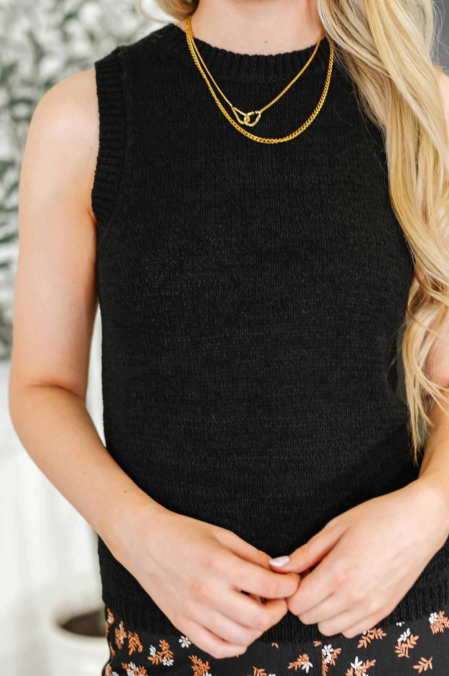 Close-up of Sloan Knit Tank in black showing textured knit fabric with ribbed neckline and banded trim detail.