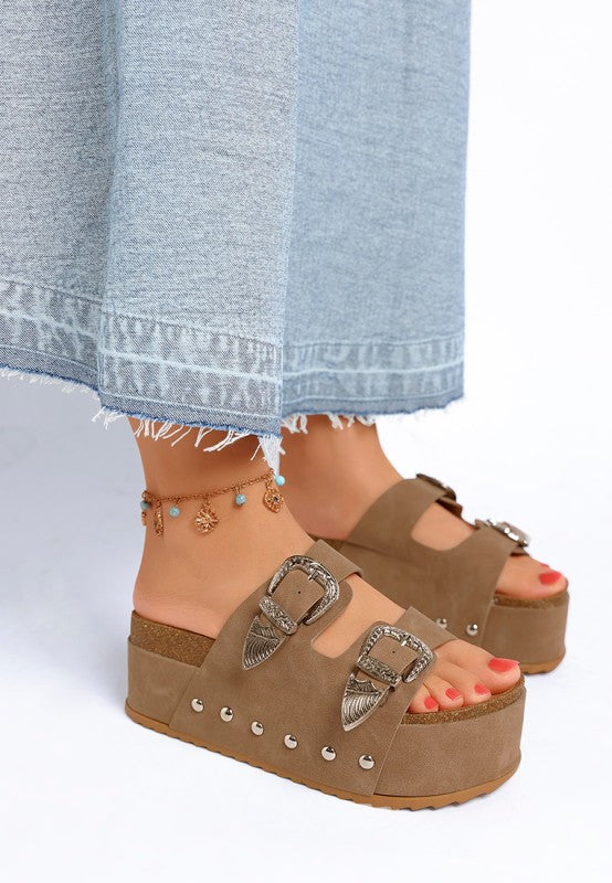 Taupe slip on sandals with chunky flatform sole and stud embellishments side angle.