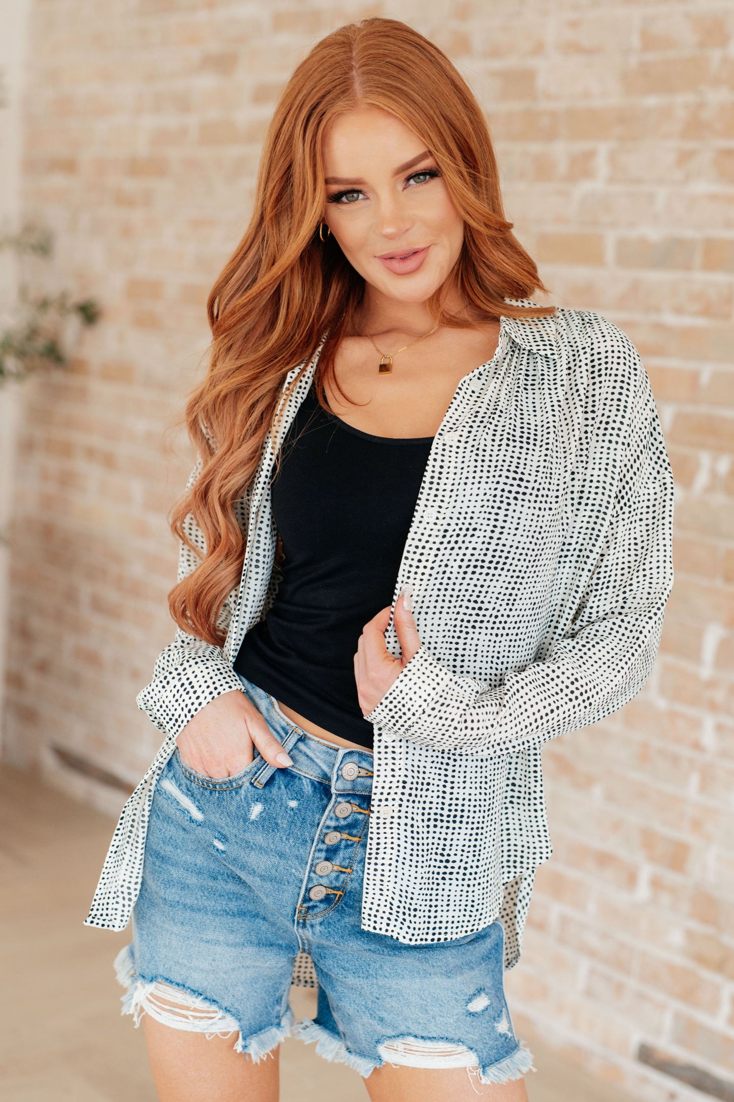 Model in Brandi Dolman Sleeve Button Up, black/white patterned satin fabric with button-down front