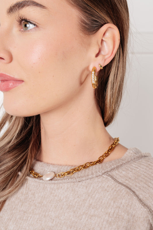 Model wearing Finest of Fine Jewelry Set with pearl ring, earrings, and shell pendant necklace styled together.