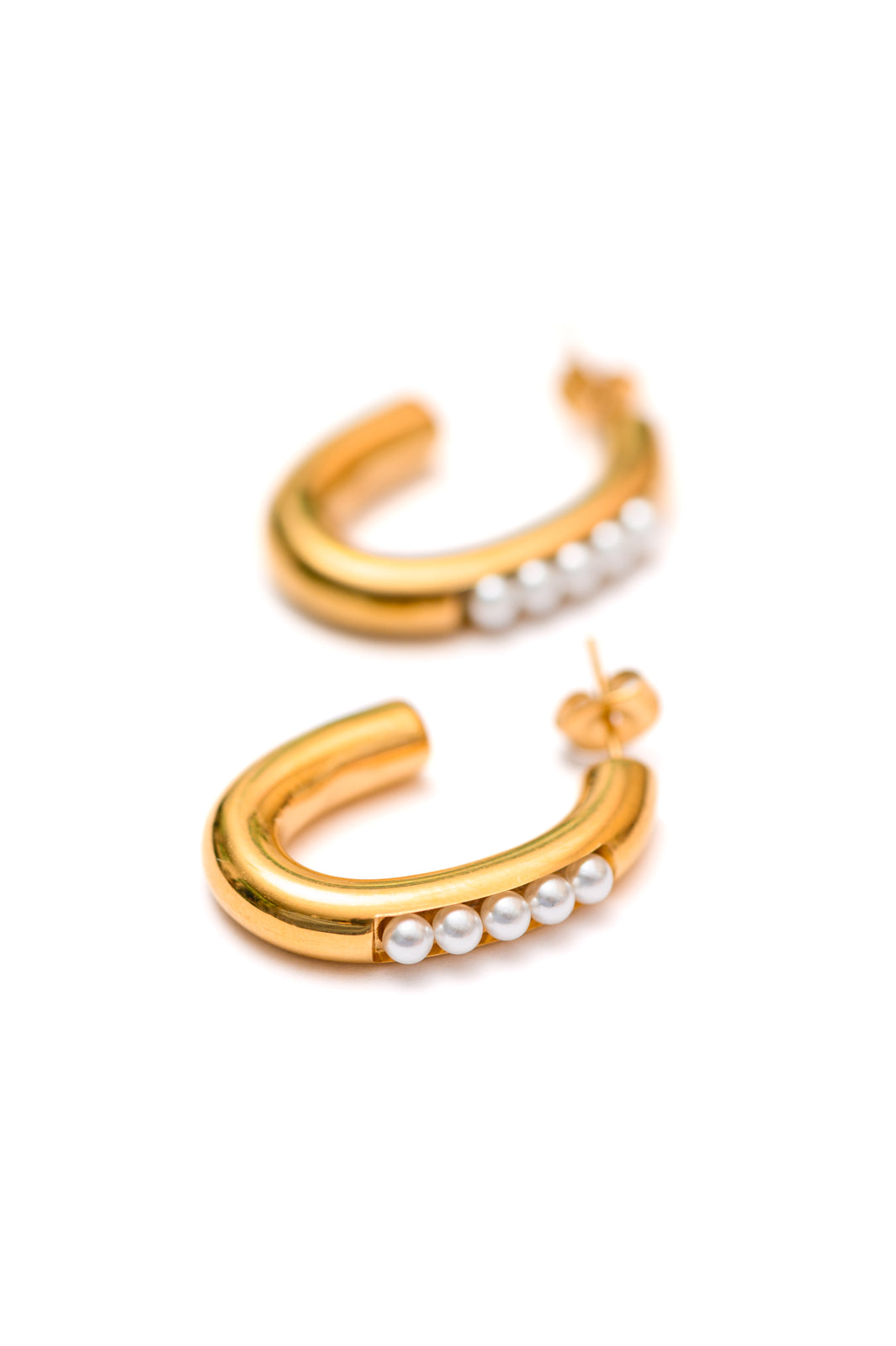 Close-up of Pearls in Line Earrings with gold hoops and delicate pearl accents.