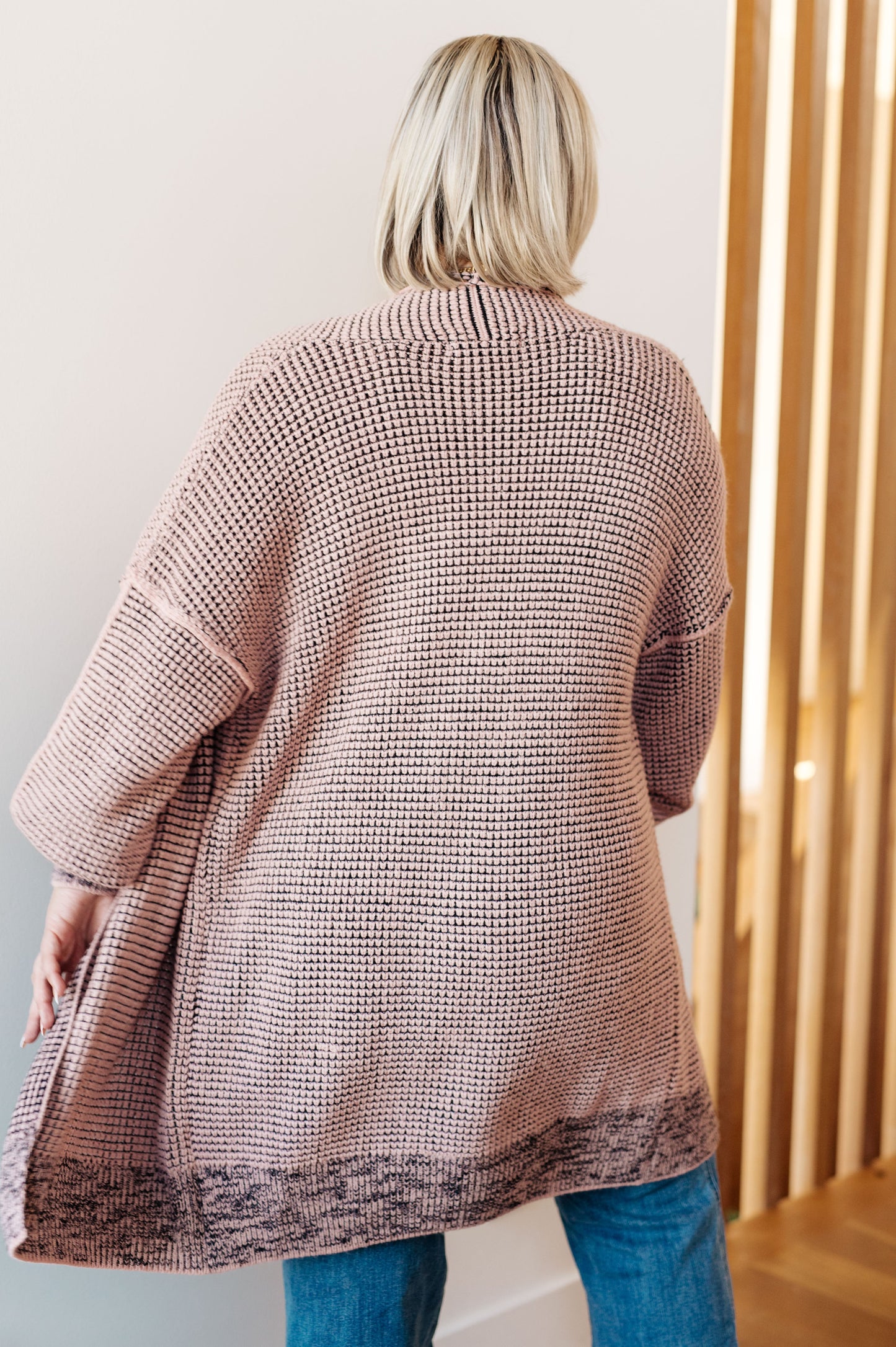 Plus size model back view of Ginni Mauve Cardigan, exposed seam detail