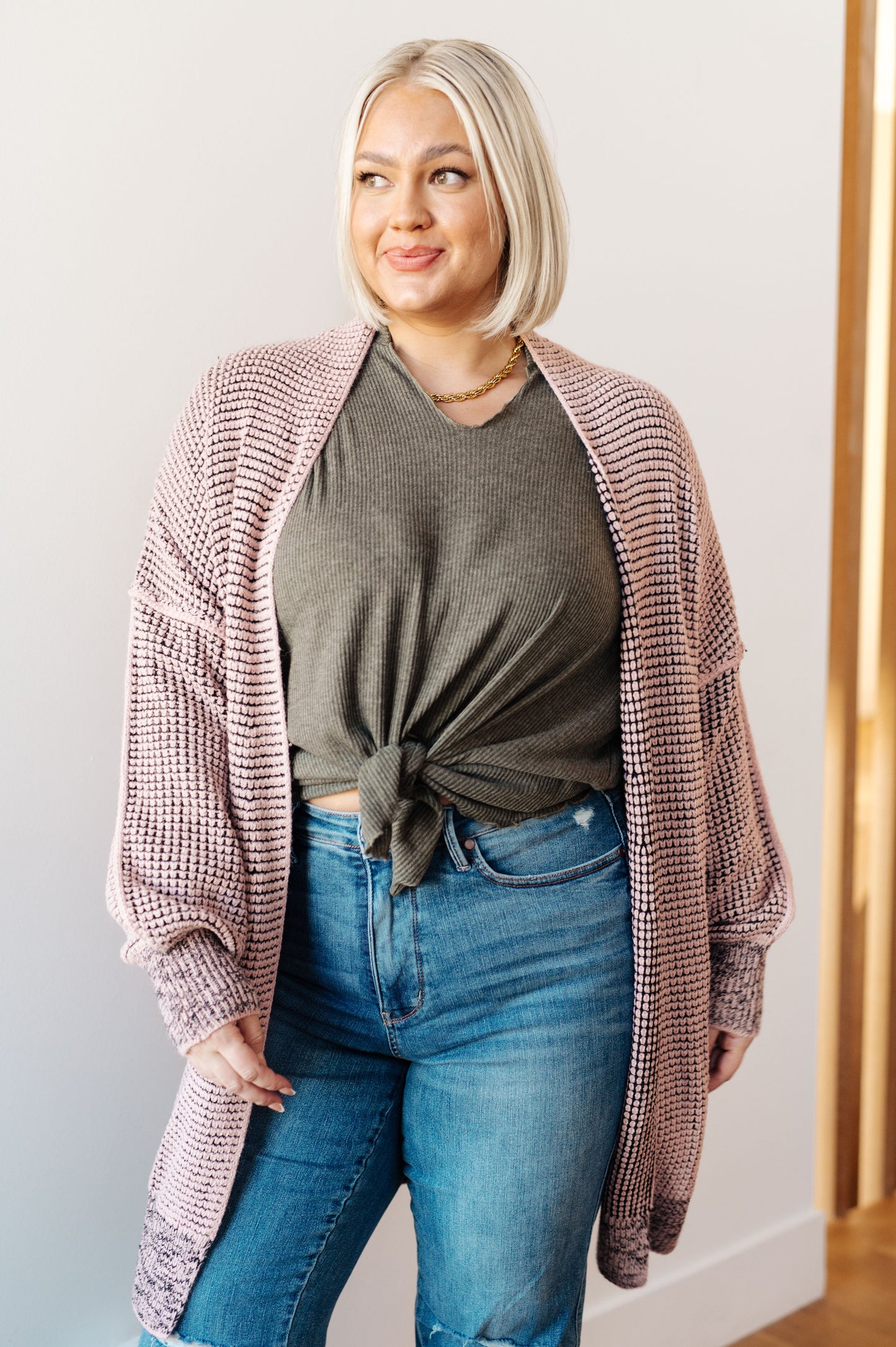 Plus size model wearing Ginni Mauve Cardigan, open-front layering piece with exposed seams