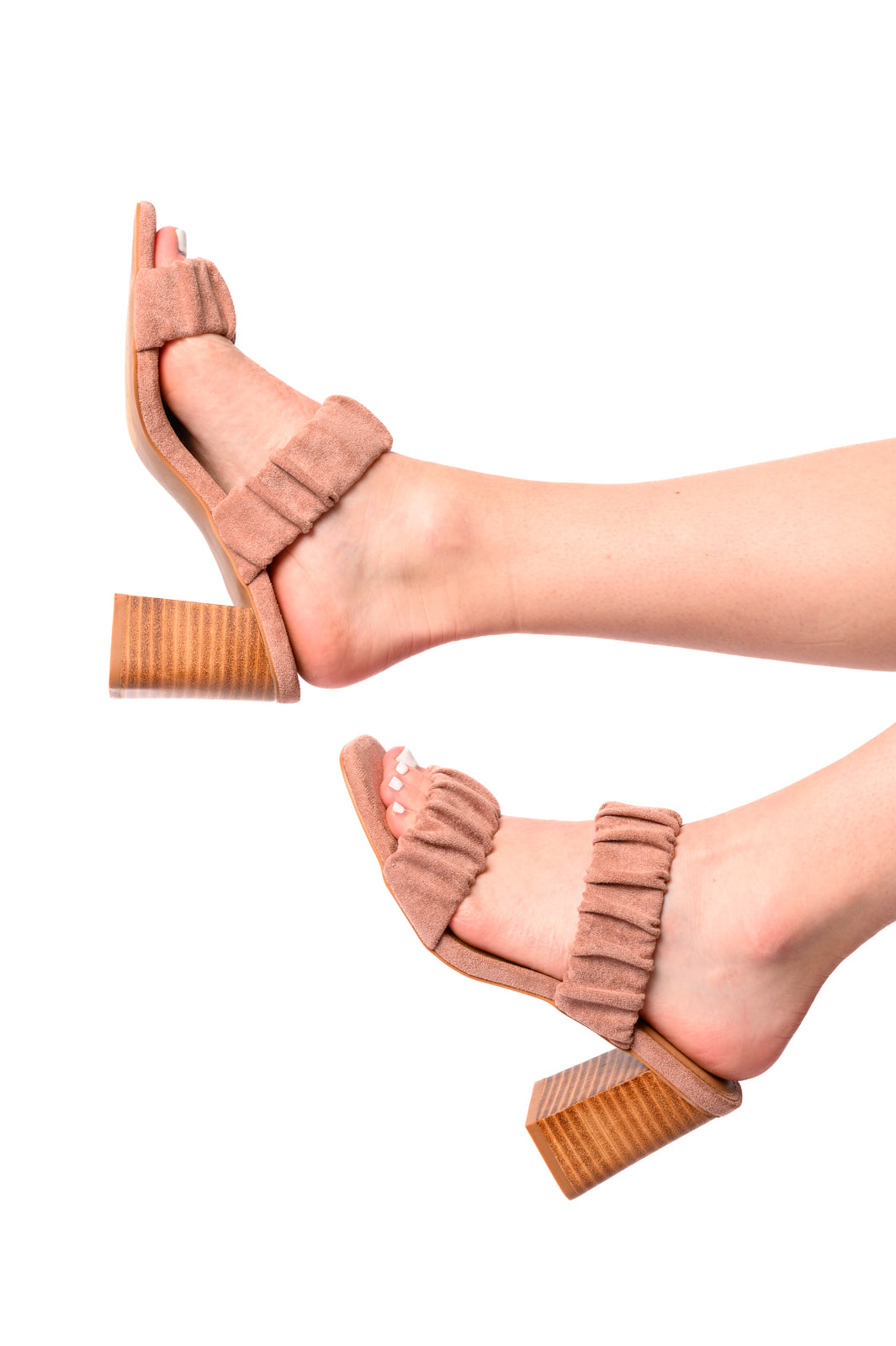 Woman wearing blush suede Palesa heels, side view showing 3-inch heel and open square toe.