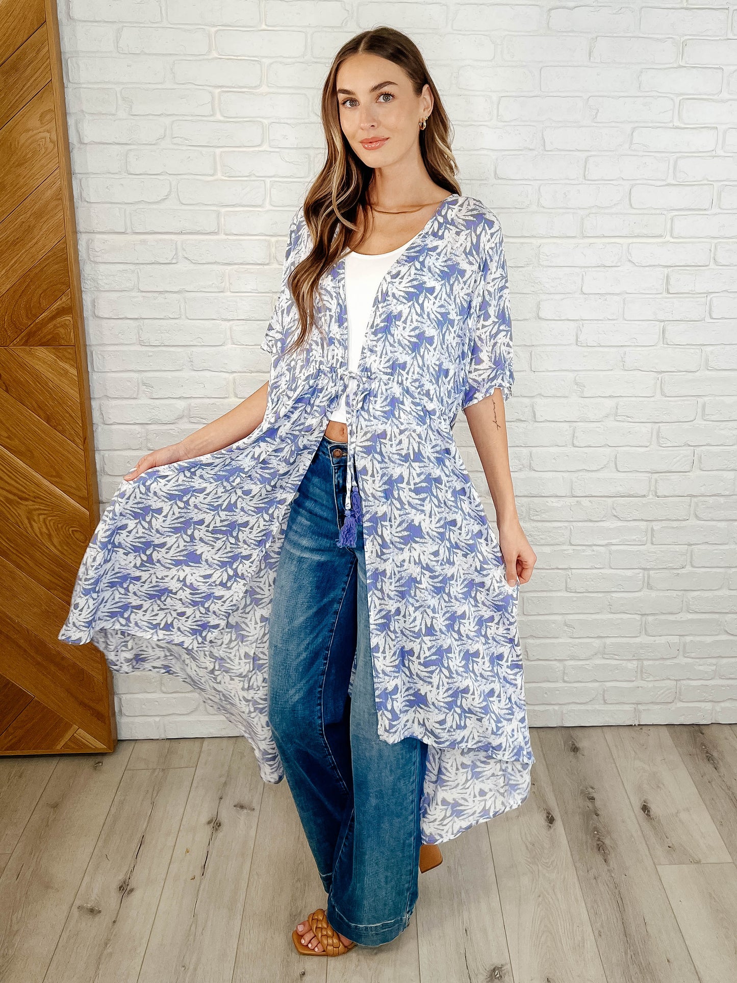 Model in periwinkle tropical kimono, dolman sleeves, casual summer outfit.